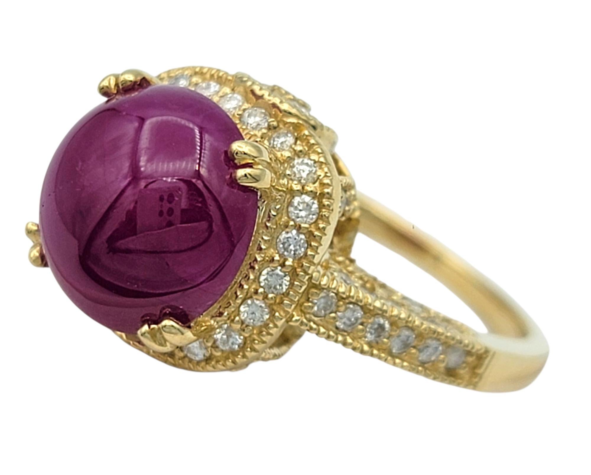 Ring Size: 7.25
 
Make a bold and regal statement with this breathtaking Burmese ruby and diamond ring. At the center lies a vivid round cabochon ruby with a rich, velvety red hue that glows with warmth and depth. Its domed surface adds a soft,