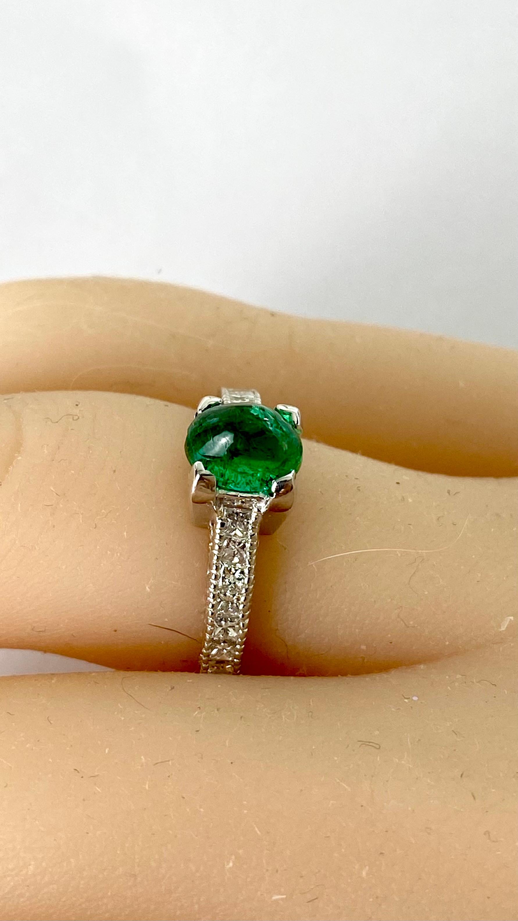 Introducing our exquisite 14 Karat White Gold Oval Cabochon Colombian Emerald Engagement Ring, a masterpiece of fine craftsmanship and timeless elegance.
At the heart of this magnificent ring is a stunning 1.10 carat oval cabochon Colombian Emerald,