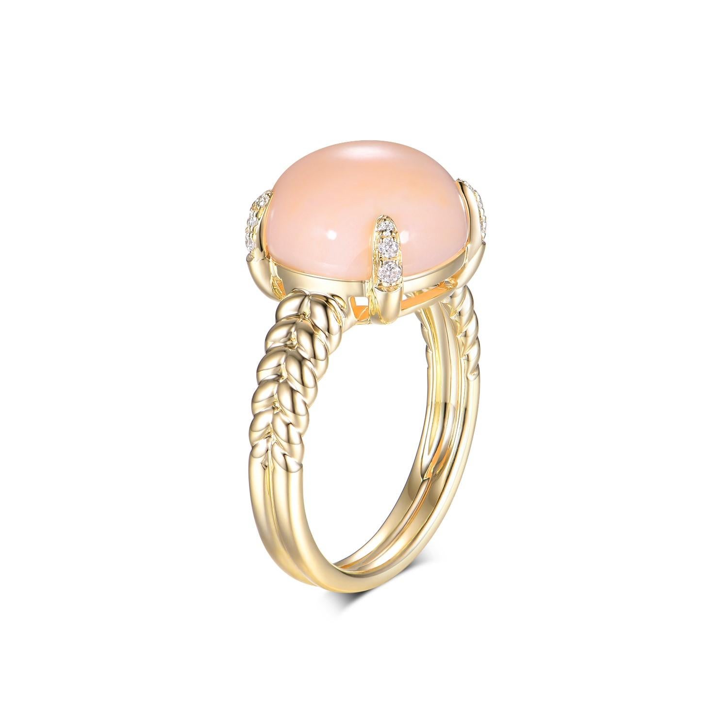 This ring is a stunning piece of jewelry crafted from 14-karat yellow gold, featuring a large, round coral center stone weighing 7.0 carats. The coral has a delicate pink hue that exudes a soft, warm glow, reminiscent of a serene sunset. Its smooth