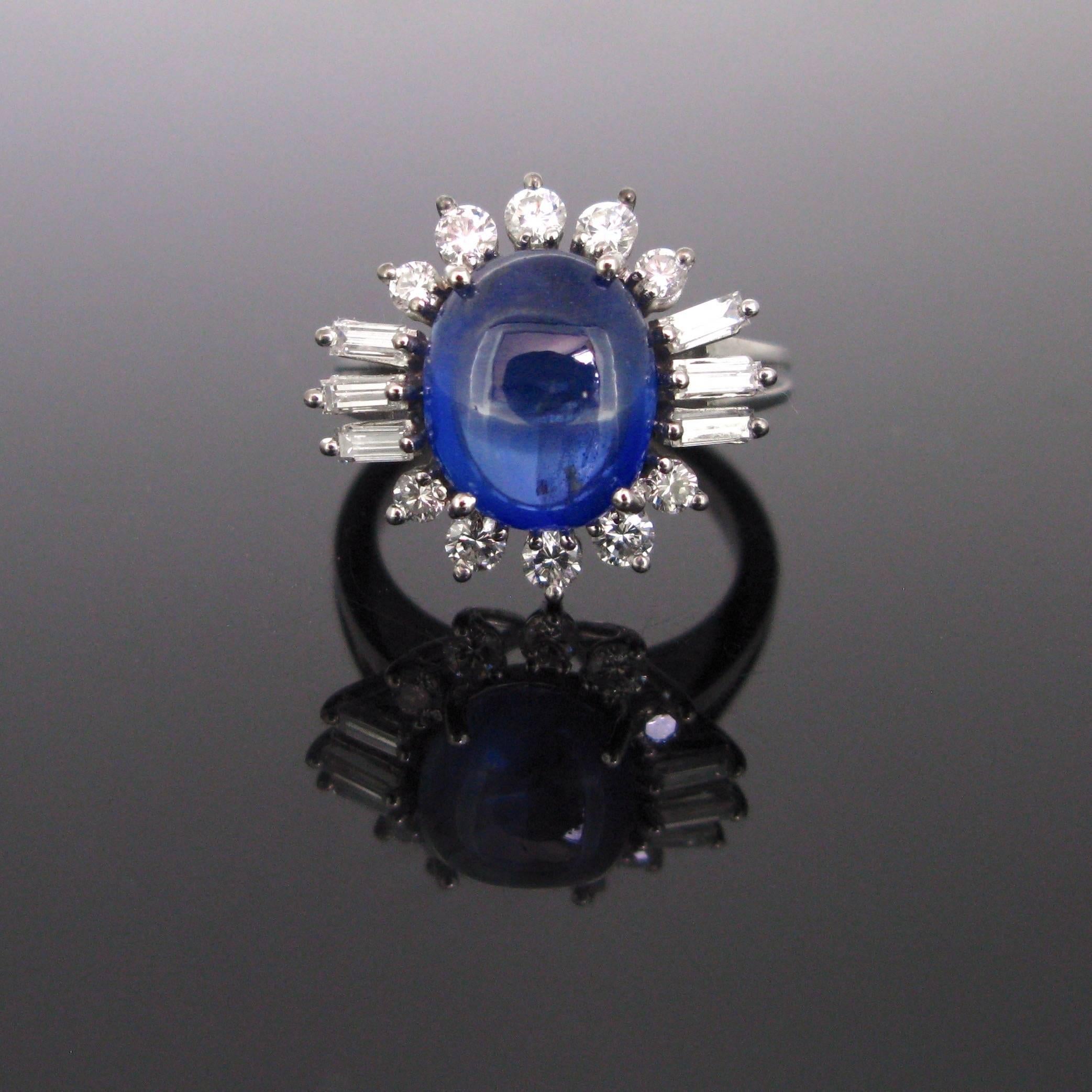 This beautiful ring is made in 18k white gold and features a cabochon cut Ceylan sapphire with an approximate weight of 6.20ct and no indication of heating. It comes with a GCS certificate. It is surrounded by 16 diamonds – 10 round brilliant cut