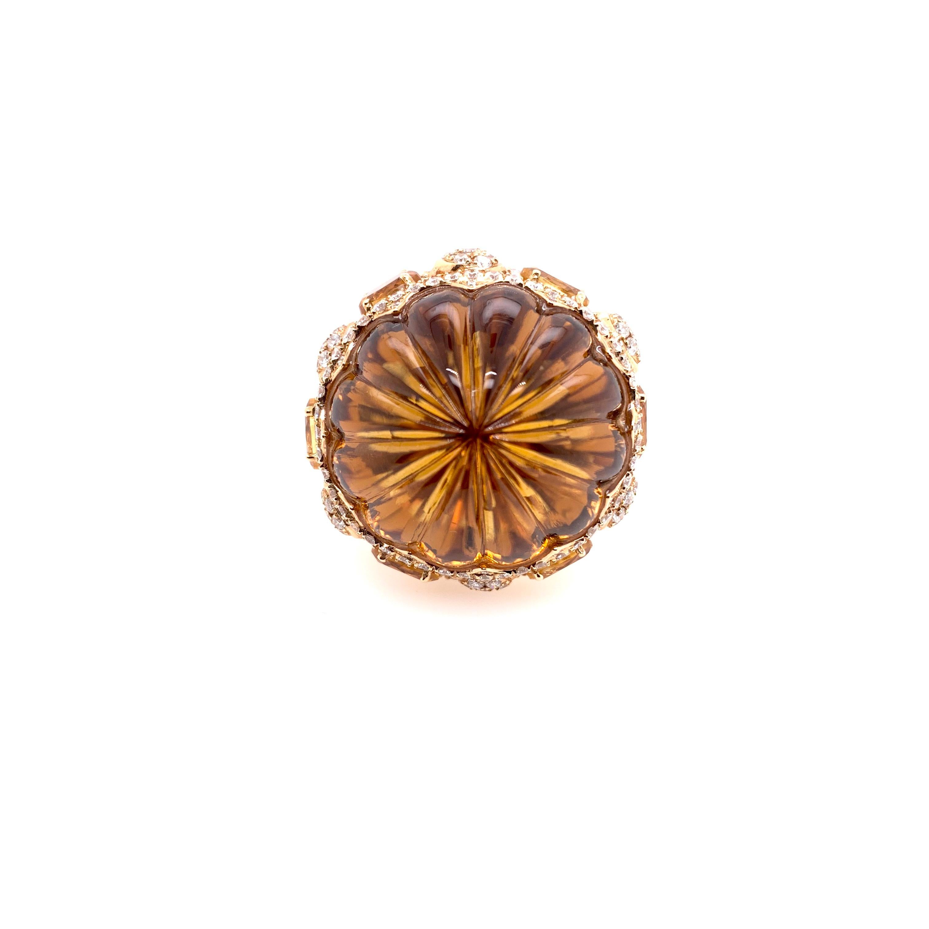 This stunning cabochon citrine sits atop of a custom setting surrounded by citrine and diamonds along the equator.  Set in 18k yellow gold, this unique citrine attracts all eyes as its profile commands authority and attention!  The citrines add up