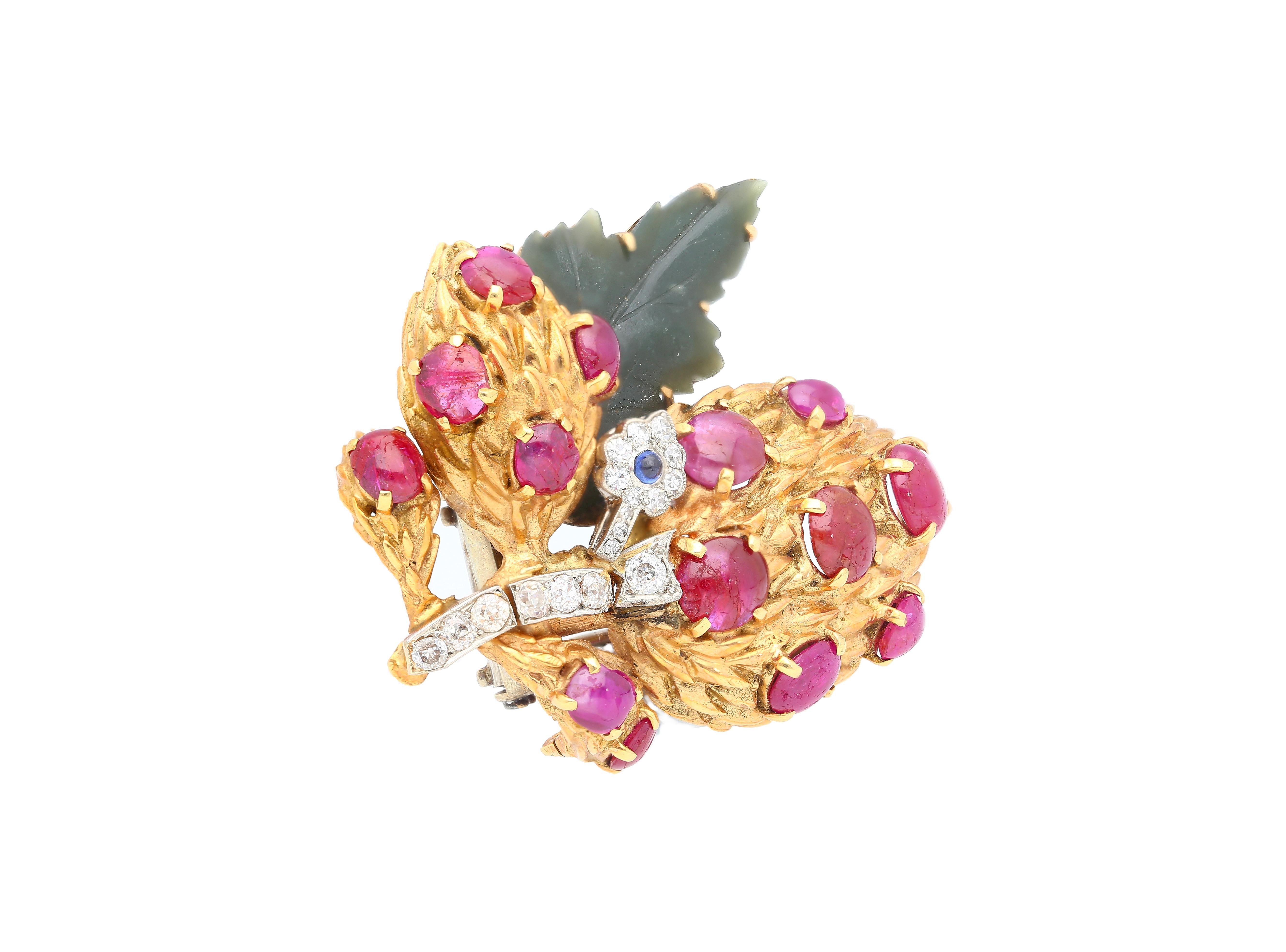 Jewelry Details:
Item Type: Brooch Pin
Metal Type: 18K Yellow Gold and Platinum
Weight: 35.70 grams

Center Stone Details:
Gemstone 1: Ruby (Cabochon-Cut) x 14
Gemstone 2: Sapphire (Cabochon-Cut) x 1
Gemstone 3: Carved Jade x 1
Gemstone 4: Diamonds