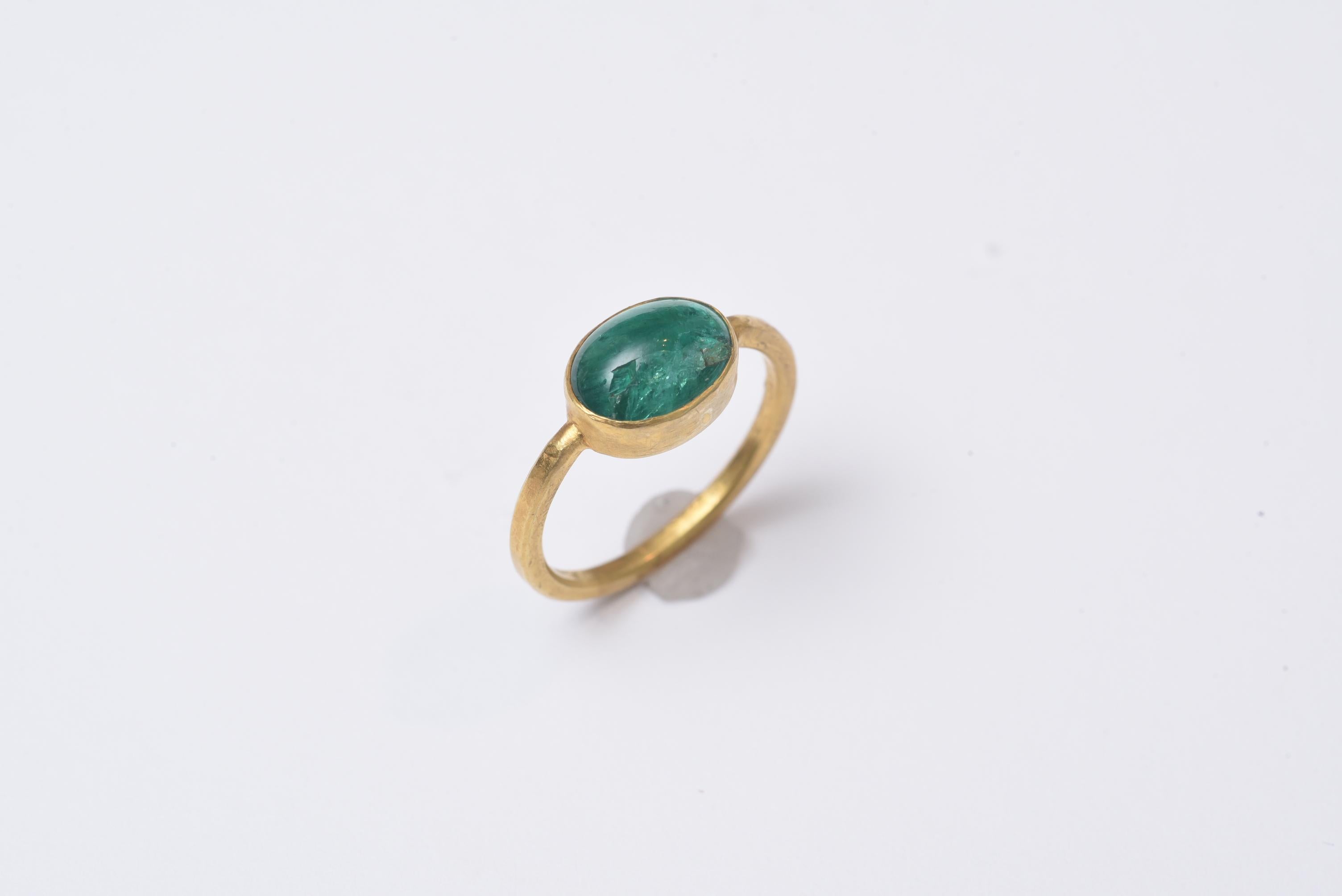 Cabochon emerald solitaire ring set in a nicely simple 22K gold band.  Ring size is 6.75.  Mid-1900's.