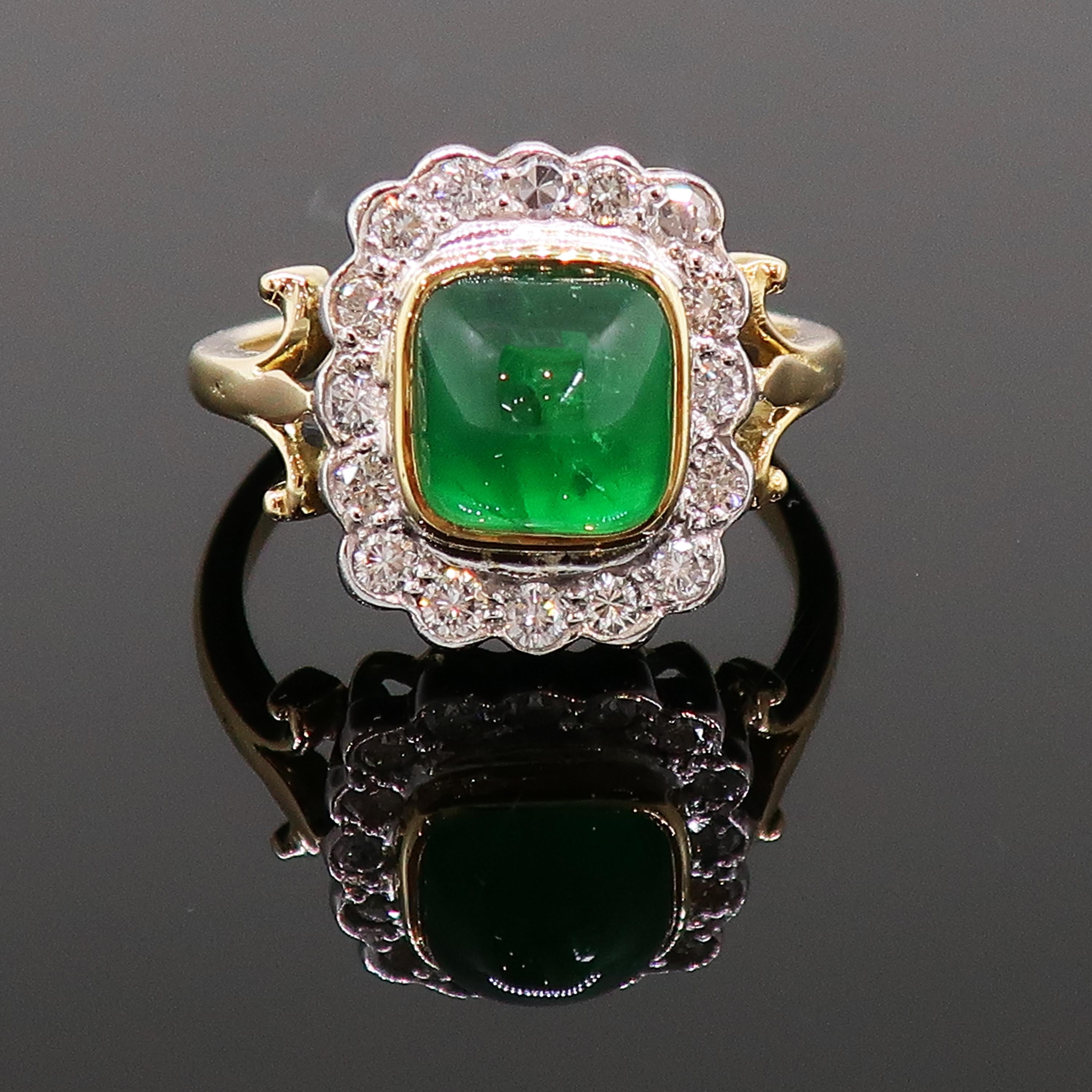 Cabochon Emerald and Diamond Cluster Ring 18 Karat Yellow and White Gold

Dazzling cushion cut cabochon emerald and diamond cluster ring. Stunning central cushion sugarloaf cabochon emerald encased in a yellow gold bezel, surrounded by sixteen white