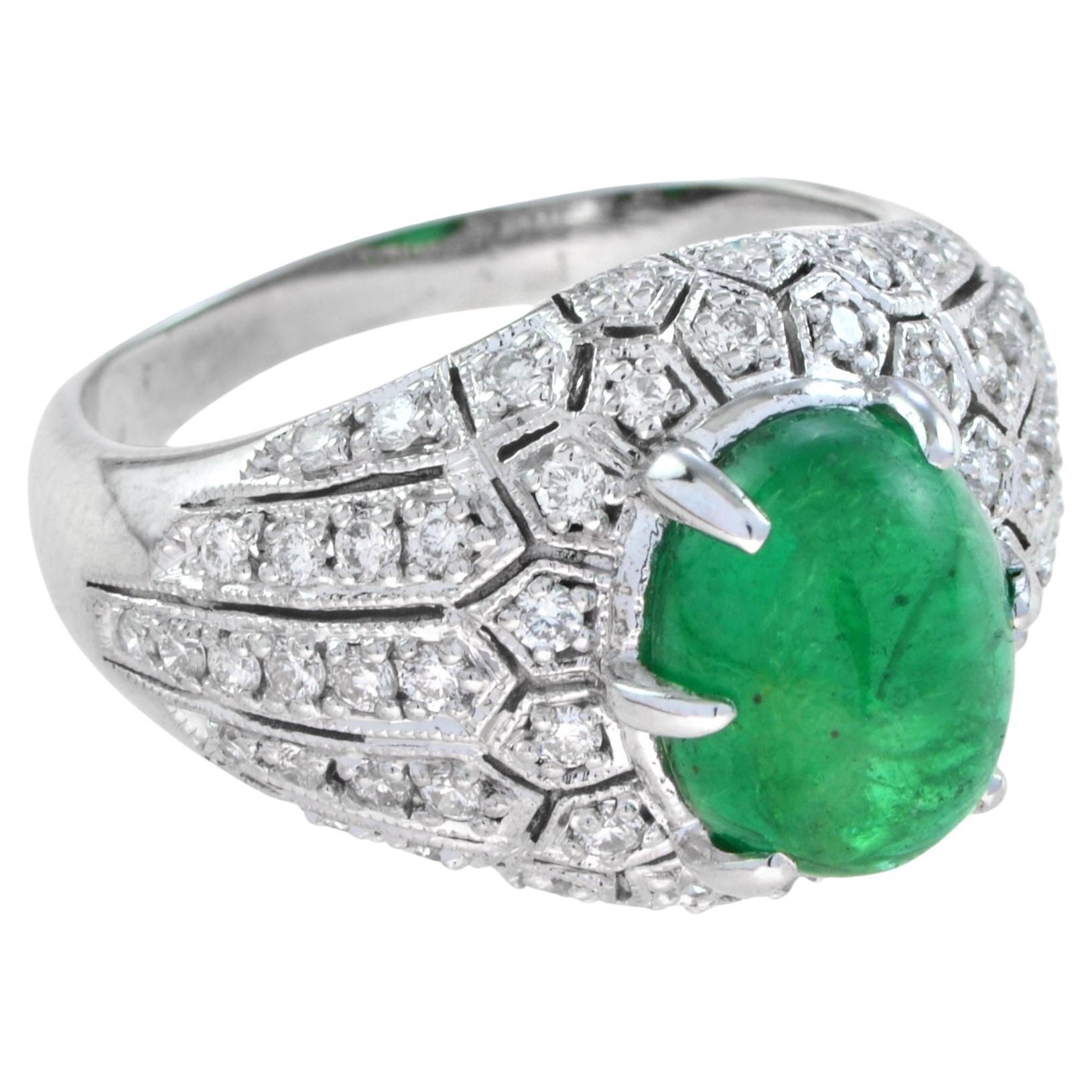 This emerald and diamond ring is a bold and scintillating statement. In the very center, an cabochon absinthe green emerald of incredibly vibrant hue sits perched above the shimmering diamond backdrop. Ready to wear from day to evening with style