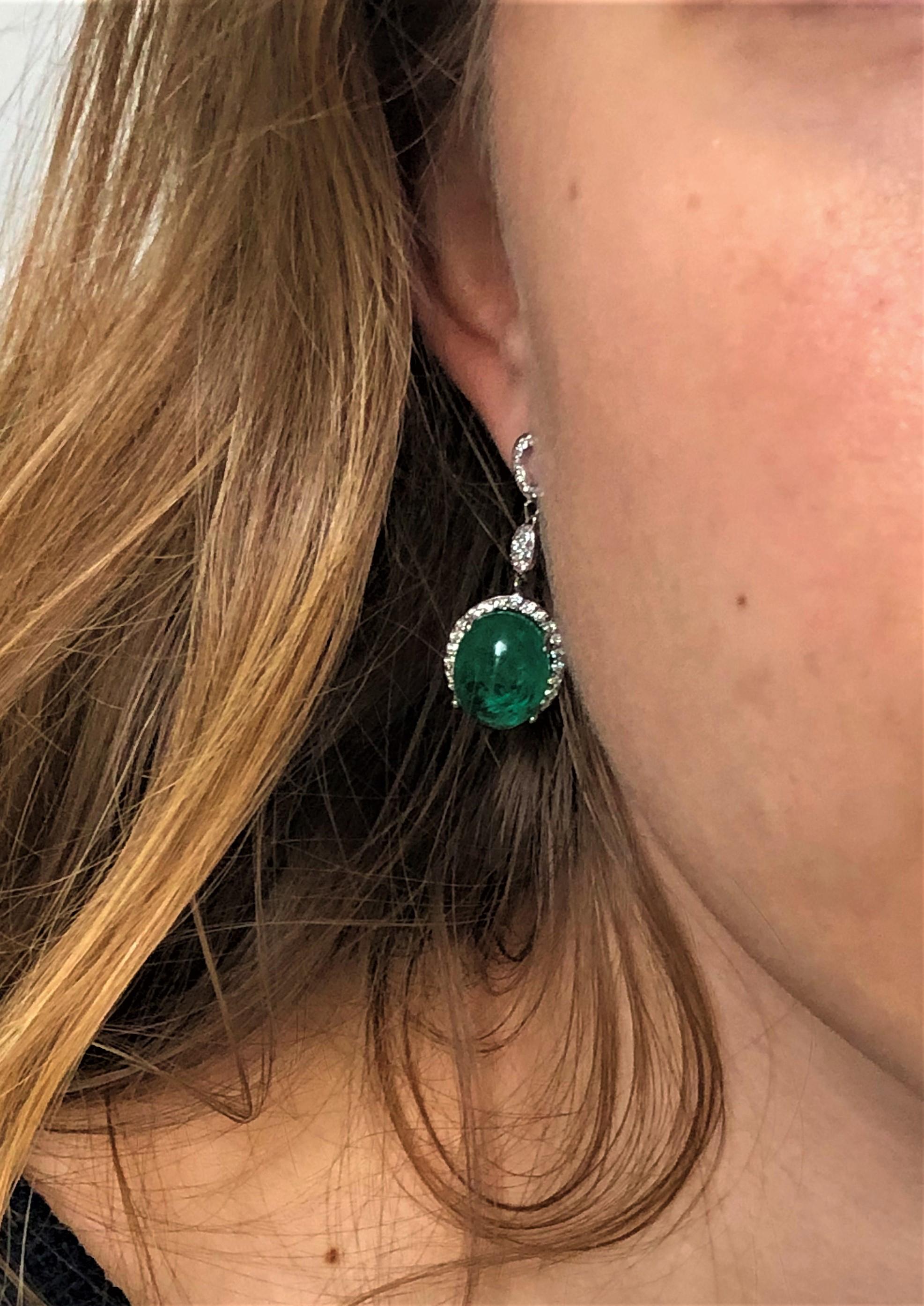 Fourteen karat white gold large cabochon emerald and diamond drop earrings 
Diamond weighing 1.45 carat
Cabochon emeralds weighing 12.76 carat 
New Earrings
One of a kind earrings 
Handmade i
Fourteen karat gold earrings are hanging off a post with