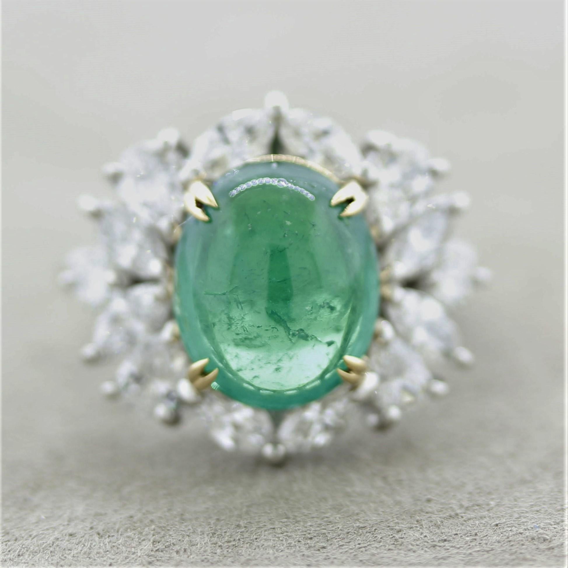 A superb gem emerald takes center stage of this platinum made ring. It weighs 4.87 carats and has a gemmy vivid grass green color that rivals the finest of emeralds on the market. It is complemented by 2.15 carats of round brilliant, marquise, and