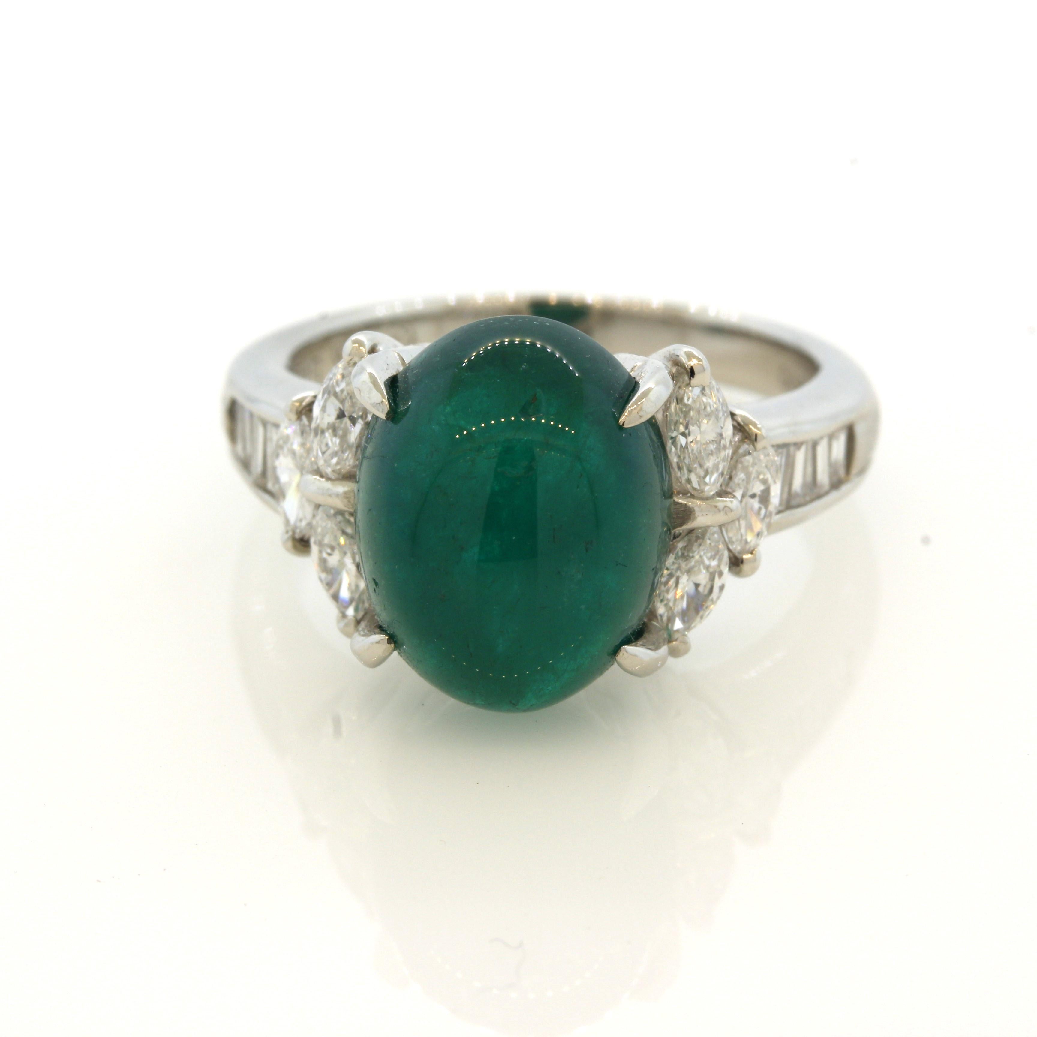 A lovely ring featuring a luscious cabochon emerald weighing 6.62 carats. It has a rich deep green color that will hypnotize you if you stare at it for too long! It is complemented by 0.76 carats of marquise and baguette-cut diamonds set down the
