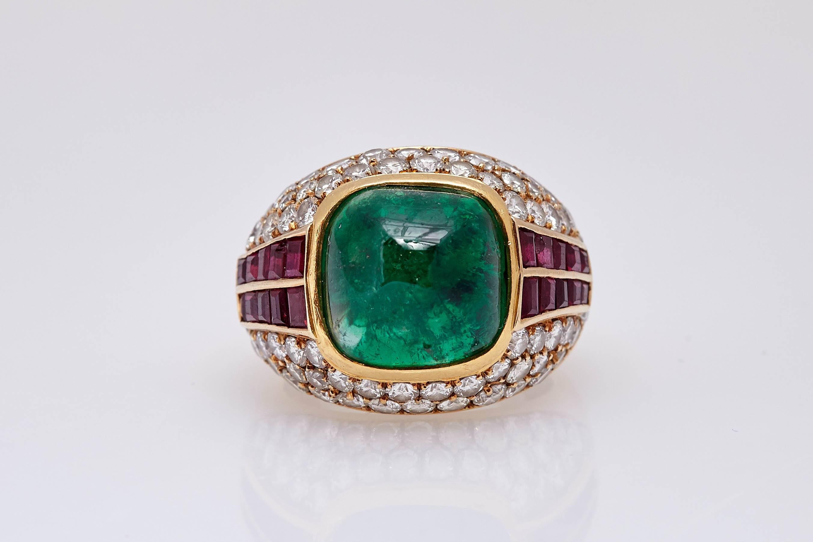 A sophisticated showcasing a 18ct sugarloaf emerald, set in a fine 18kt yellow gold, accented by carre set rubies and round cut diamonds. Made in France, circa 1965