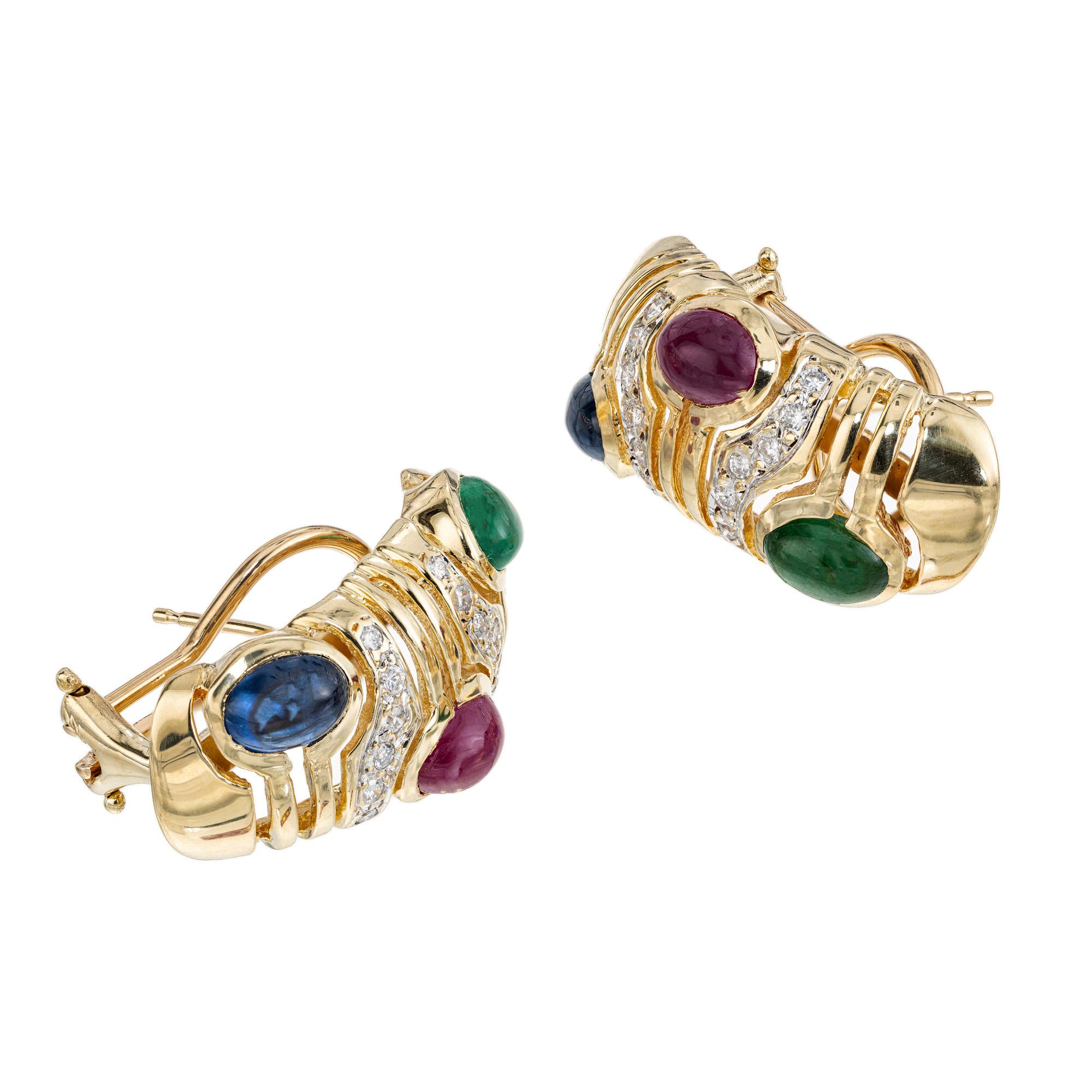 Vintage 1960's genuine sapphire and diamond earrings. Each cabochon earring is adorned with one cabochon Emerald, ruby and Sapphire gemstone. Set in 14k yellow gold, these clip post earrings are also accented 24 round cut diamonds. adding a