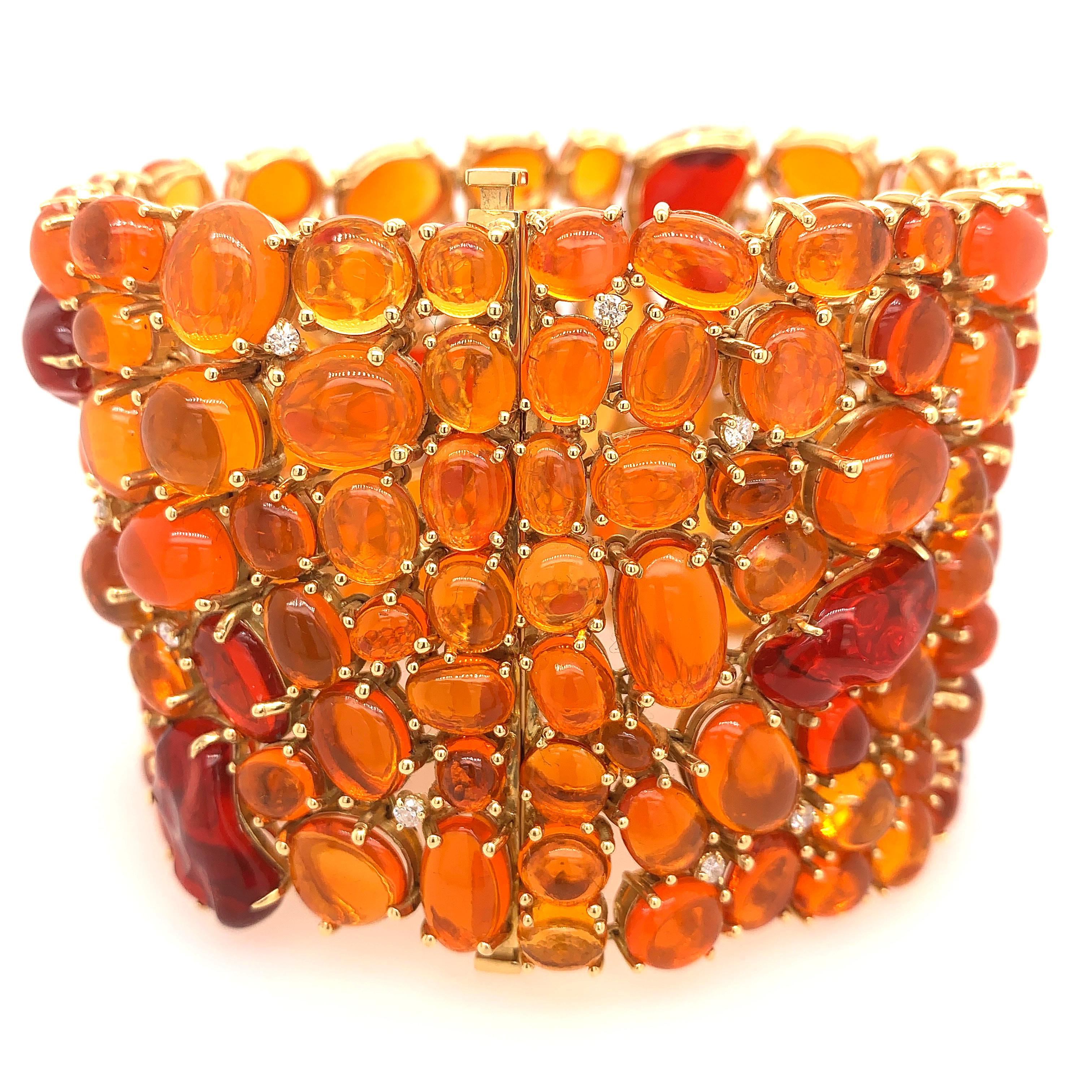 Bursts of Lava Collection

Cabochon Fire Opals and Diamond statement bracelet set in 18K yellow gold.

Fire Opal: 175.27ct total weight.
Diamonds: 0.92ct total weight.
All diamonds are G-H/SI stones.