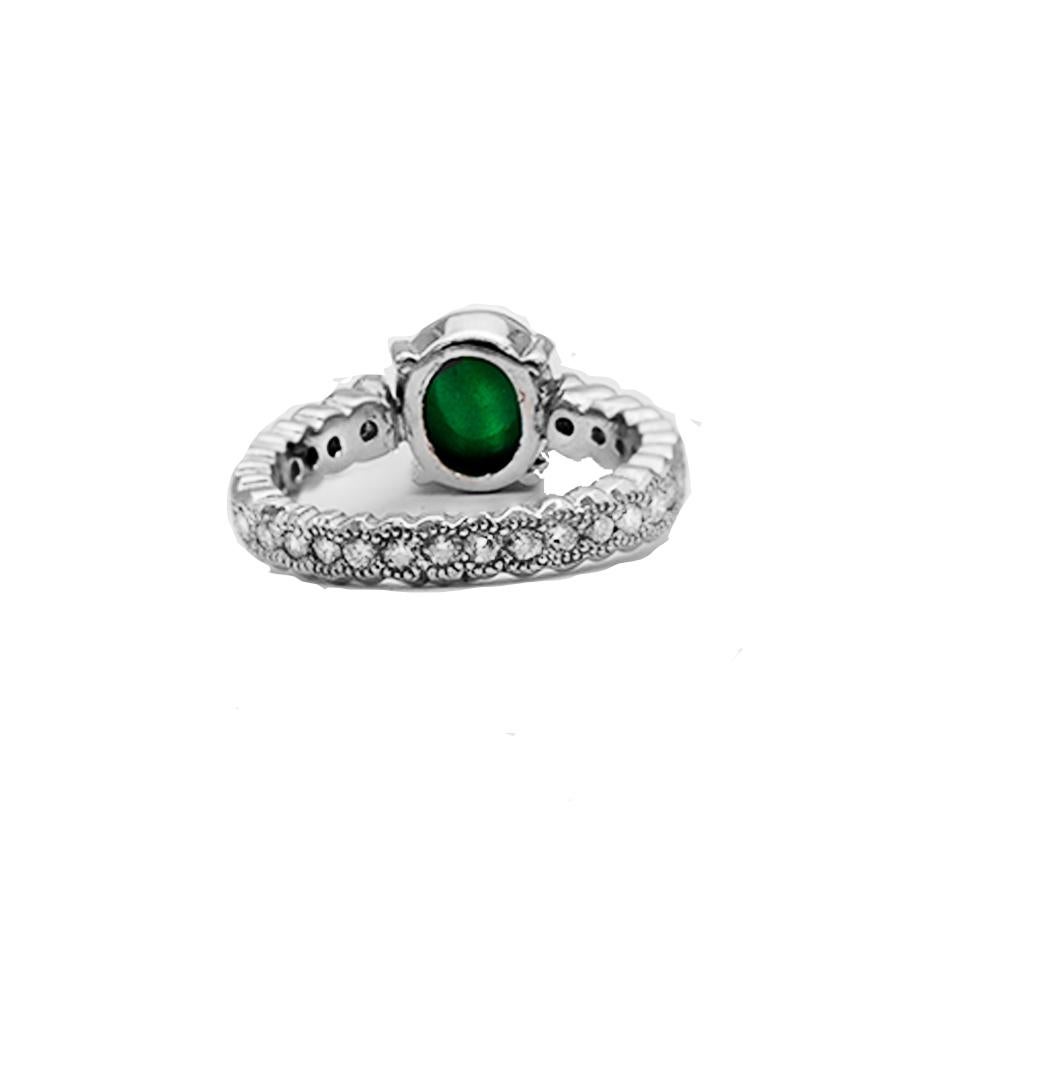 Green Jade, Eternity Platinum Diamond Ring.
 Jade is cabochon shaped  measuring 9.85 mm x 8.67 mm and set on an exquisite eternity diamond setting. The color is consistent deep color green.
 A total of  (29) round diamonds are set in bezels with