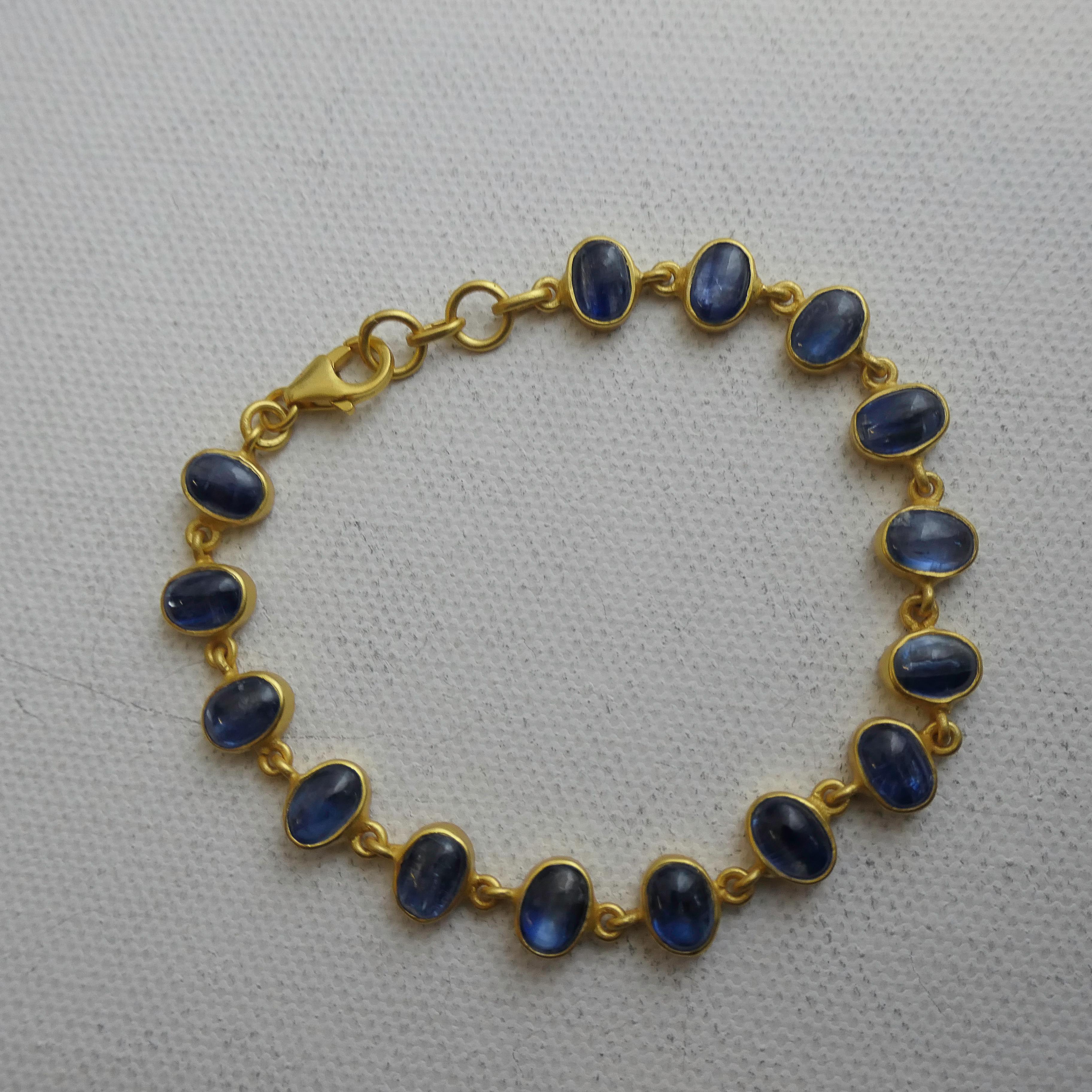 Timeless and elegant, this handcrafted bracelet features 4x6 mm oval cabochons of natural deep blue kyanite. Each gemstone displays rich, inky hues with subtle internal shimmer—unique to this striking and often underrated gem.

The stones are set in