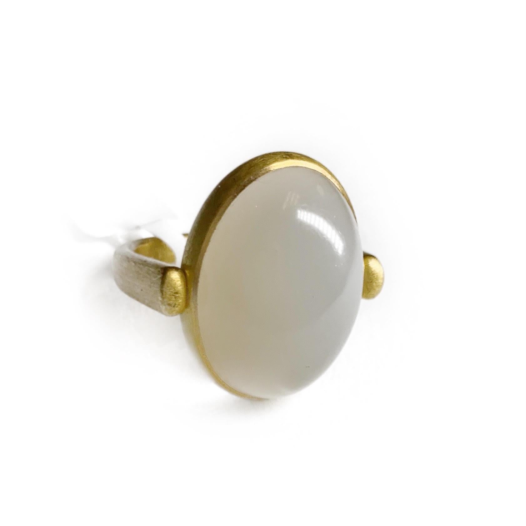 This stunning 23.55 carat moonstone cocktail ring is set in vibrant 22 karat yellow gold. The center stone is an elongated cabochon cut that swivels independently from the ring as a design feature. The gold is a soft satin finish adding to the