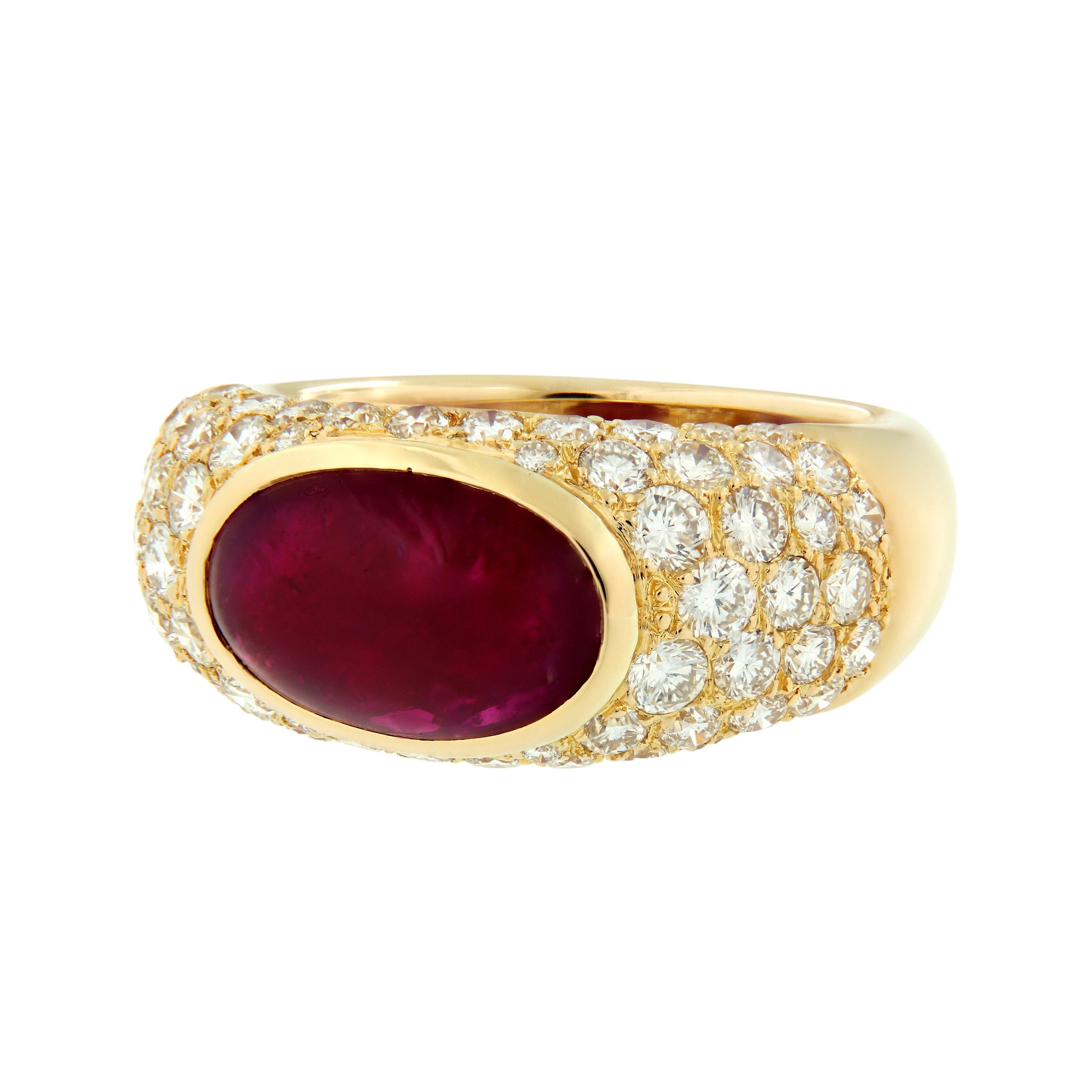 This pretty 18k yellow gold dome ring centers around a bezel-set oval-shaped cabochon ruby weighing over five carats, surrounded by almost two carats of pavé-set round diamonds. Ring size 6 1/4  Weighs 9.1 grams.

Ruby 5.22 ct
Diamond 1.78 cttw G-H