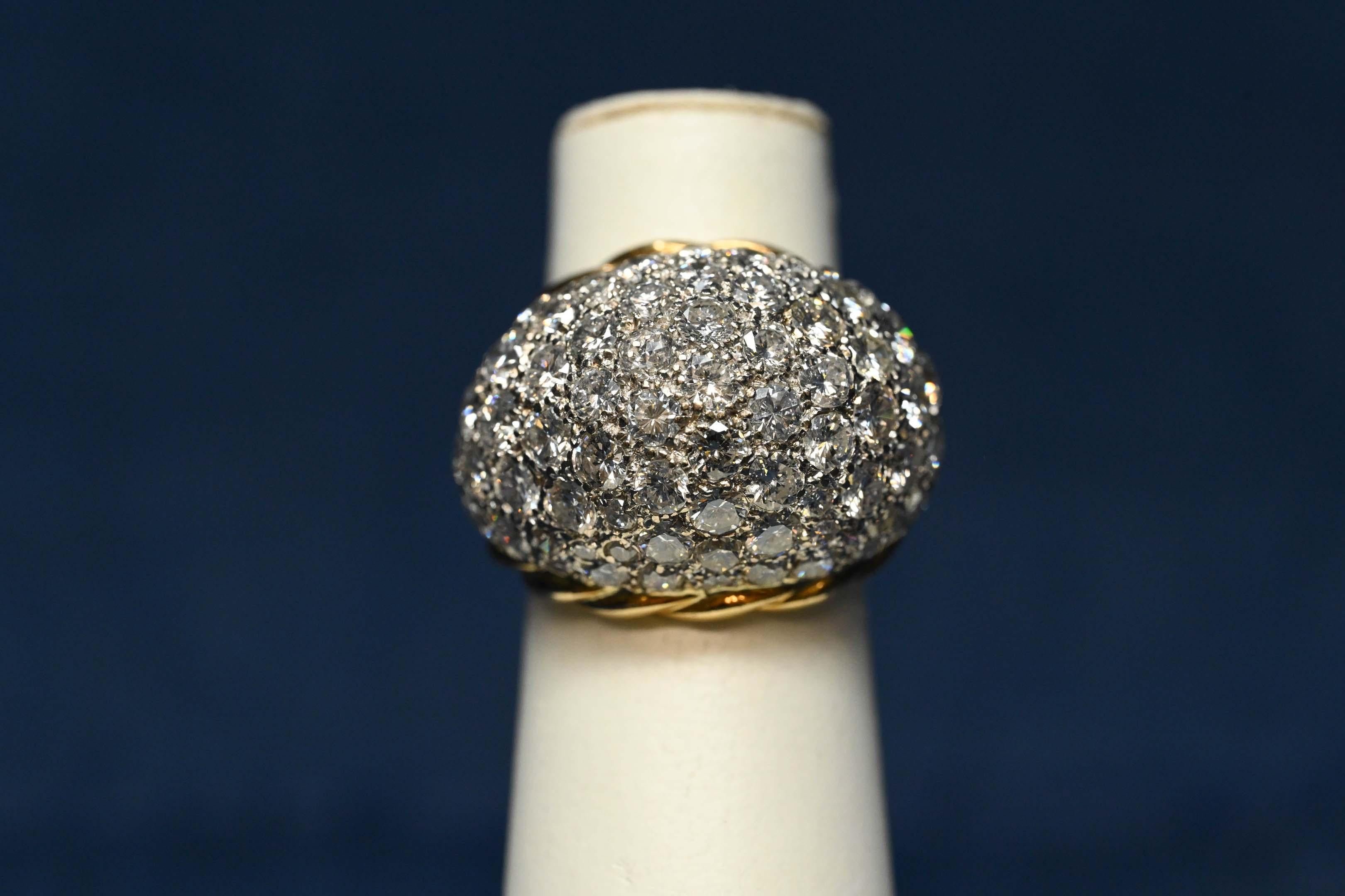 One (1) ladies ring in yellow and white 18 karat gold (by acid test), cabochon pave style, polished finish, total weight of 16.4 grams. The ring is set with approximately eighty-six (86) round brilliant cut diamonds, average weight 0.02 to 0.15