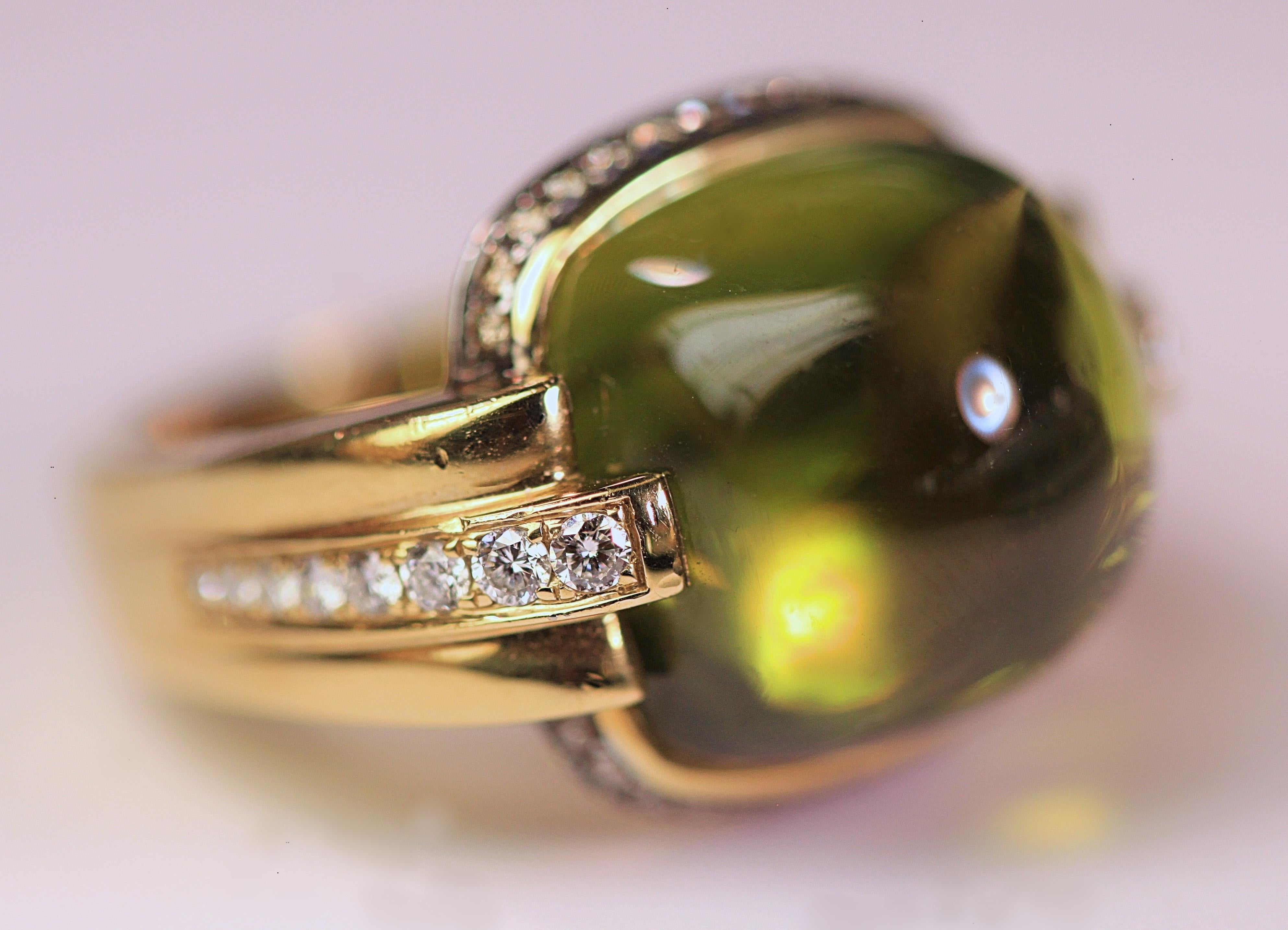 A beautiful cabochon peridot and diamond ring that was designed by Frederic Sage.  The ring is 18K yellow gold with diamonds along the sides and around the top. The ring is a size 7 1/2, but it can be resized. There are no visible inclusions to the