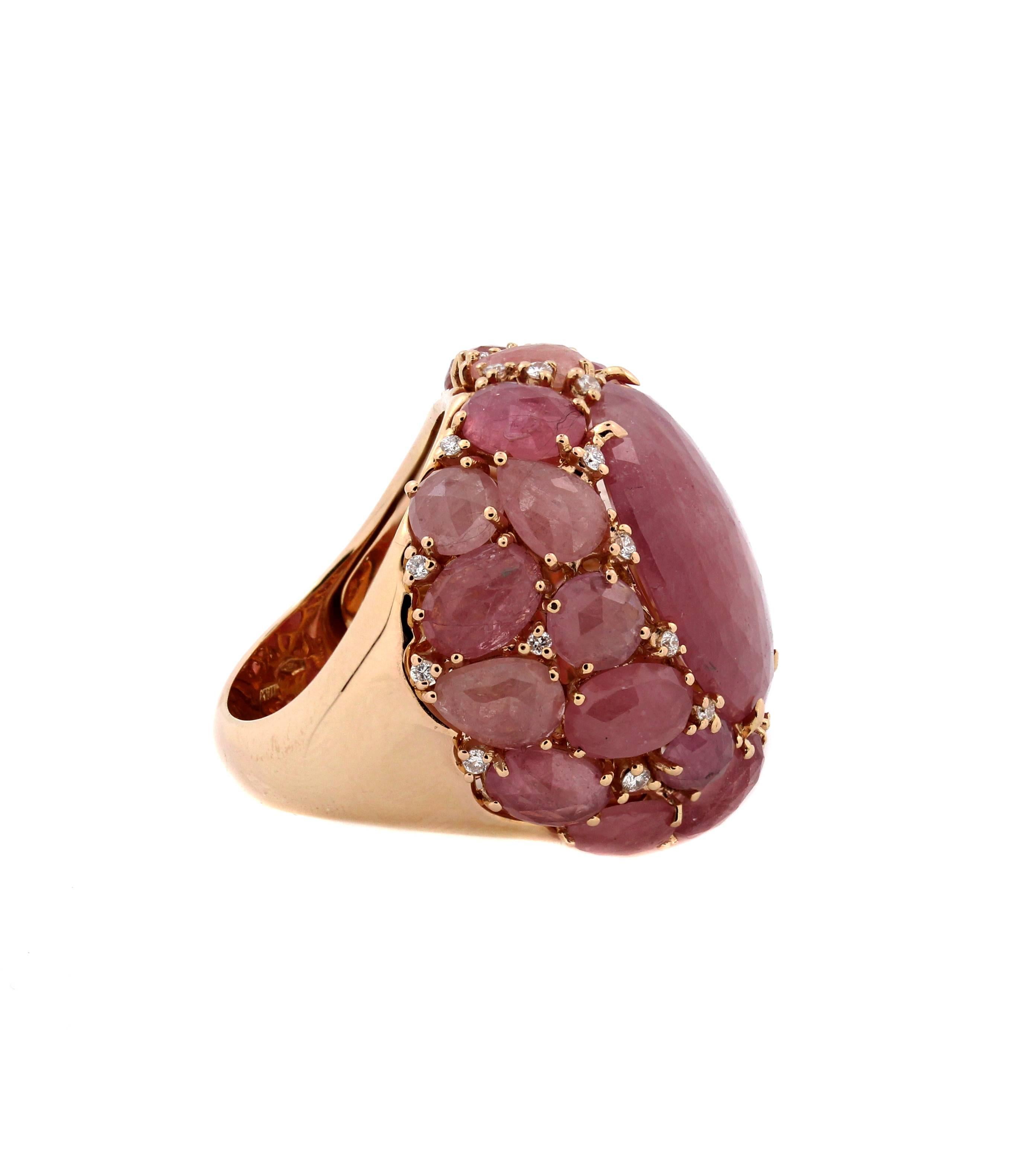 18K Gold Ring with cabochon cut Pink sapphires and diamonds by Giovanni Ferraris

This gorgeous ring features special-cut pink sapphires that are cabochon cut. Each stone was specifically cut to fit in its exact spot on this ring. There are also a