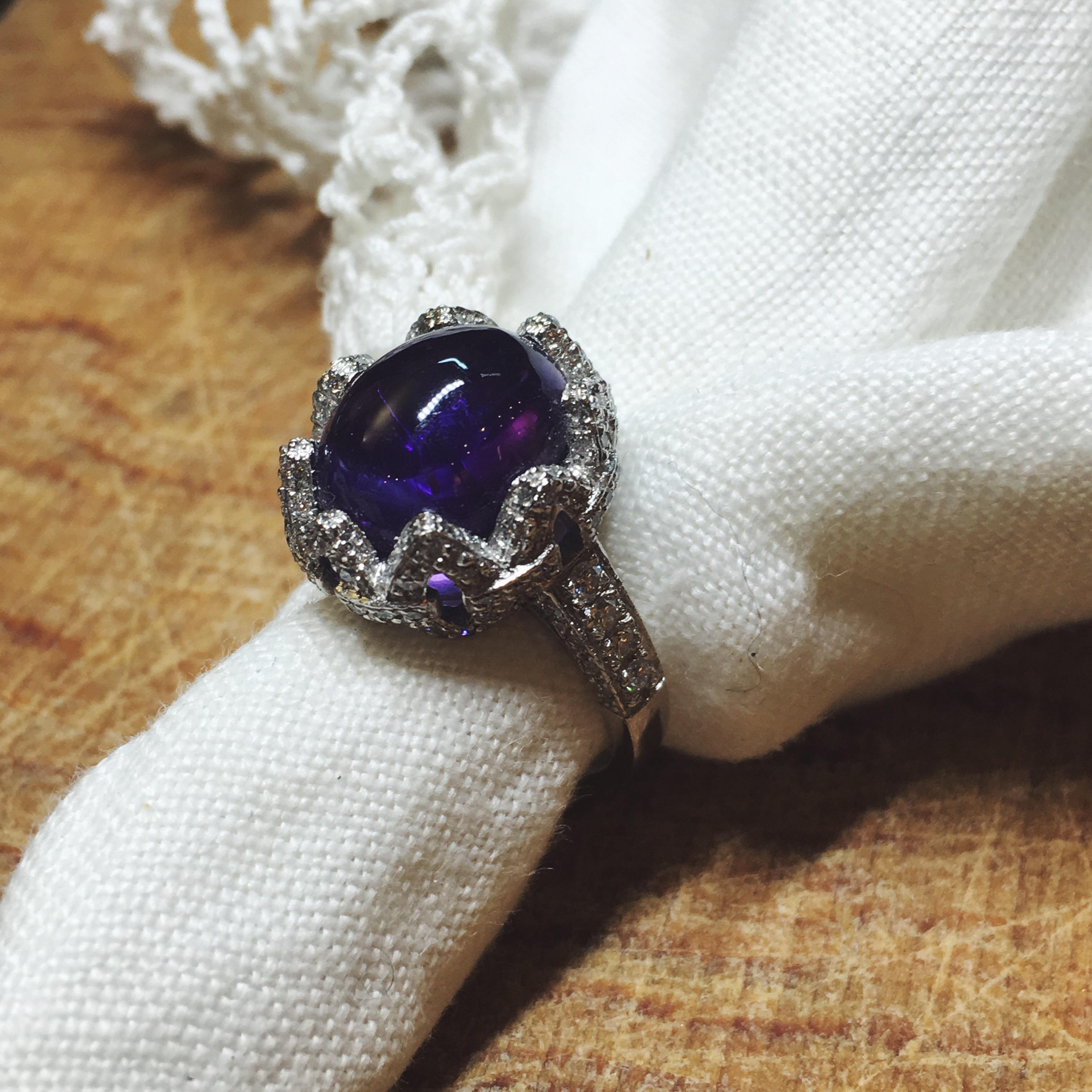 This regal Cabochon Purple Amethyst Cocktail ring is a true beauty. The central Amethyst stone is handcut in our workshop to fit perfectly in the crown of White Diamonds that surround it. This ring is a bespoke made to order piece and can be made