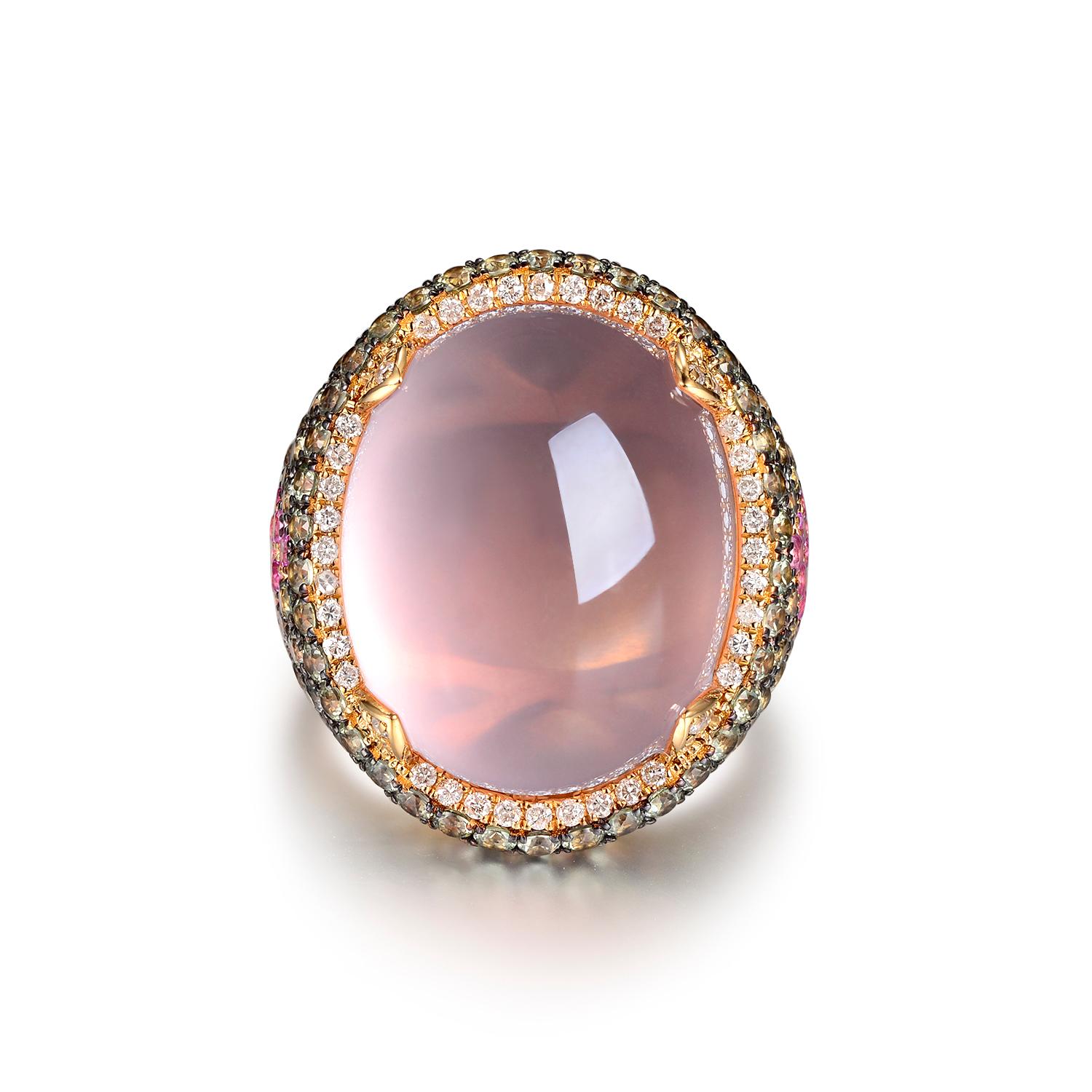 This ring features 27.95 carats of cabochon rose quartz, assented with 3.87 carats of green and pink sapphire. The shared prongs are in rhodium black gold. Prongs used to set the rose quartz are assented with 0.31 carats of white round diamonds.