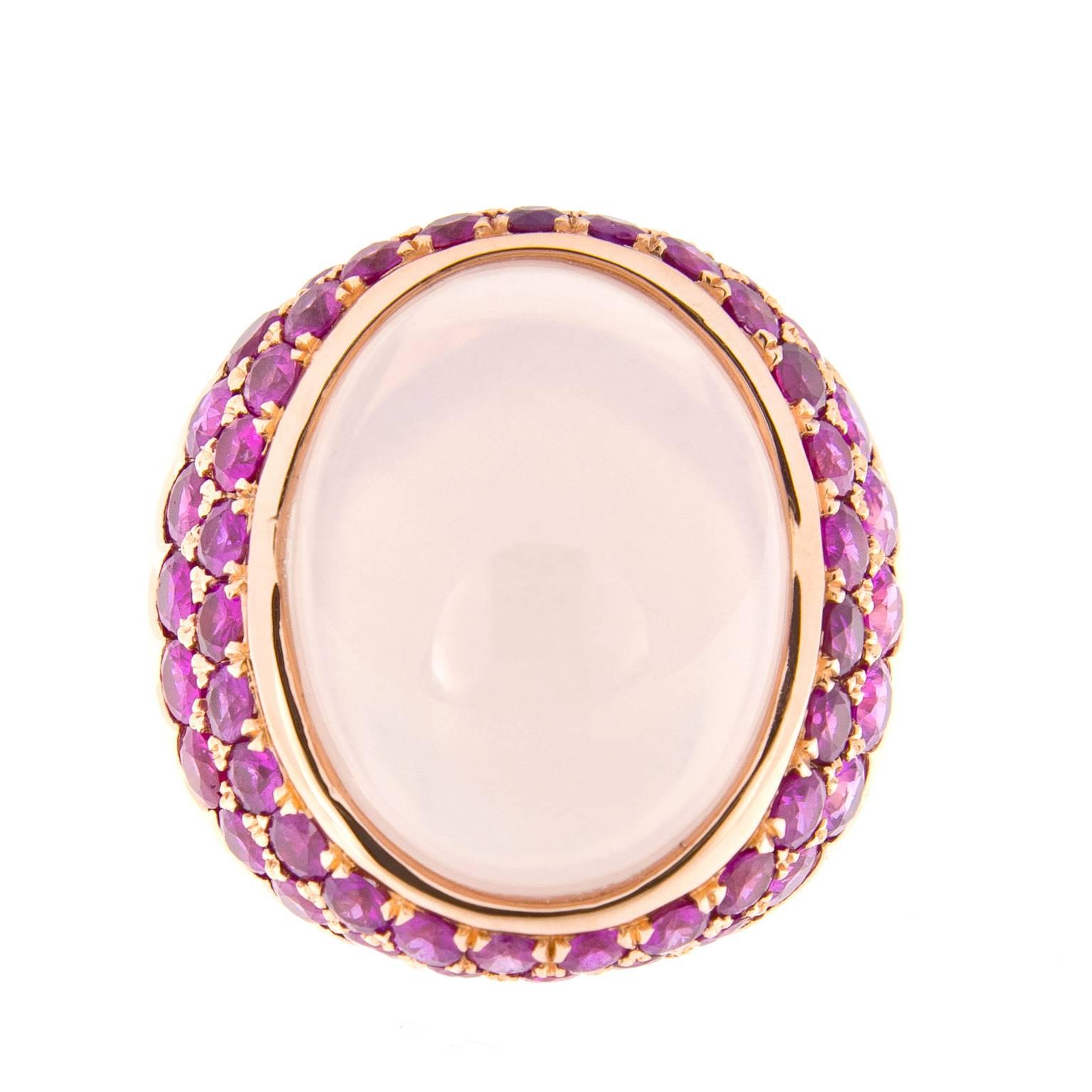Pretty in pink! The beautiful oval cabochon rose quartz is 19mm x 16mm and is surrounded by two rows of stunning pink sapphires. Ring crafted in 18k rose gold. Ring Size 6. Weighs 17.8 grams.
Handmade in New York

Pink Sapphires 4.0 cttw