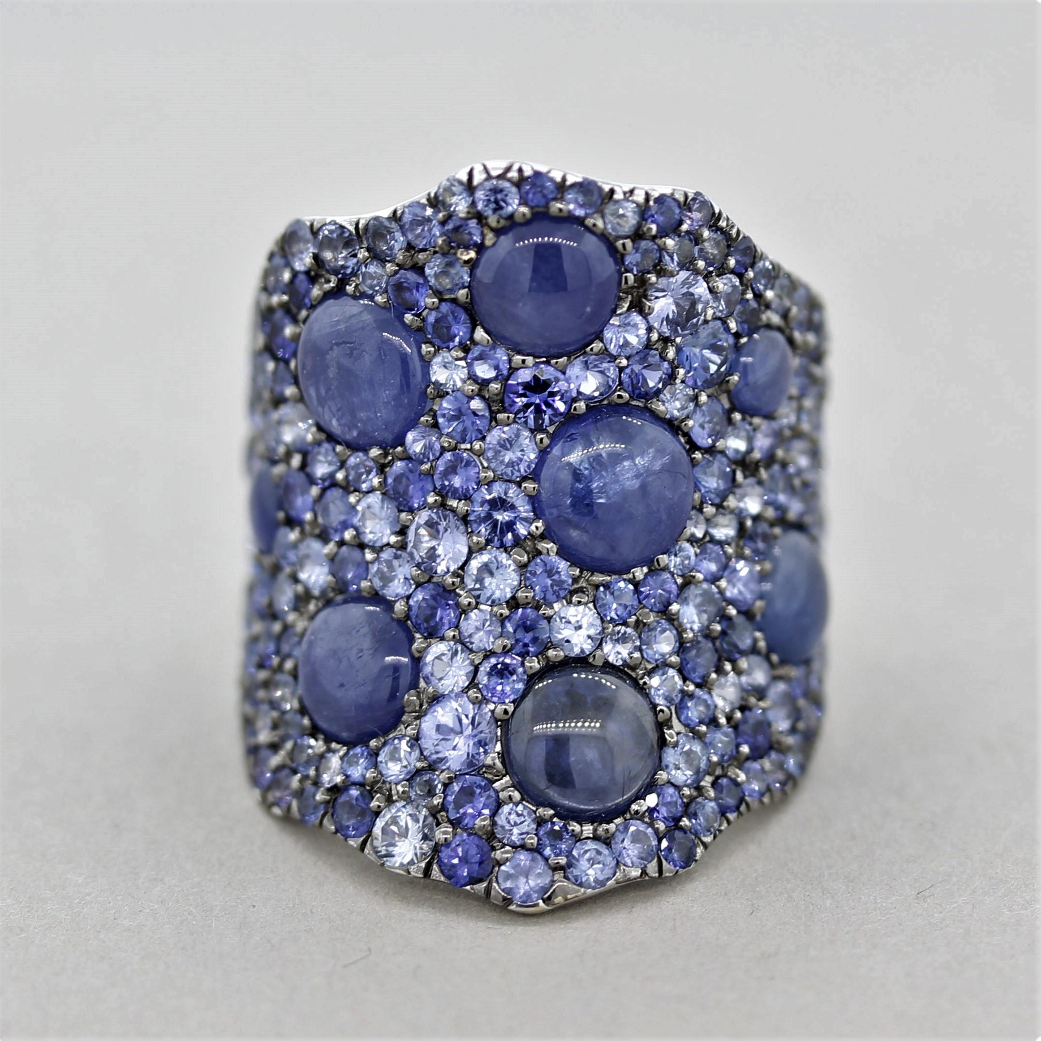 A lovely accent to any outfit! This gold ring features both smooth cabochon shaped sapphires along with round-brilliant cut blue sapphires. The cabochons weigh 4.16 carats while the round shaped sapphires weigh a total of 3.61 carats and are of