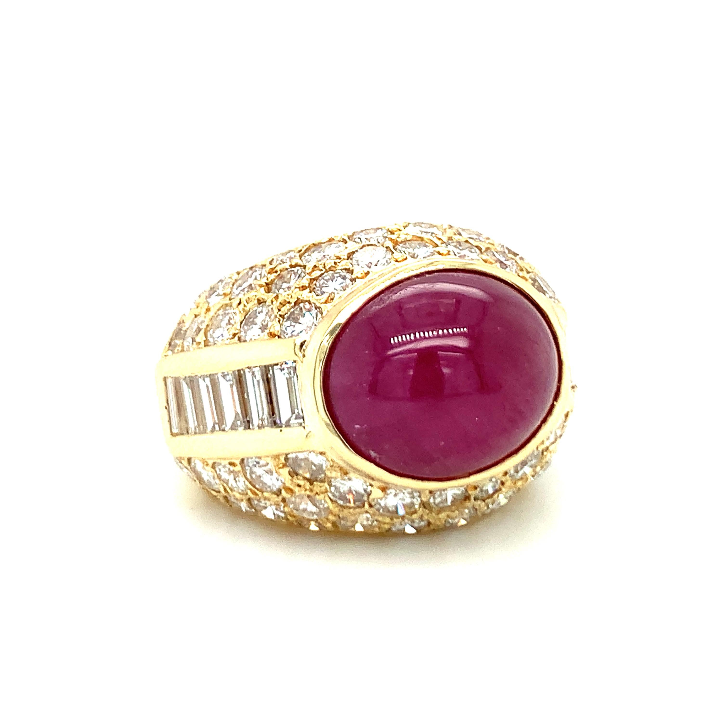 One ruby and diamond 18K yellow gold centering one bezel set, oval cabochon ruby weighing 10 ct. with GIA Report stating no heat treatment. Enhanced by seventy straight baguette and round brilliant cut diamonds totaling 3.45 ct. with G-H color and