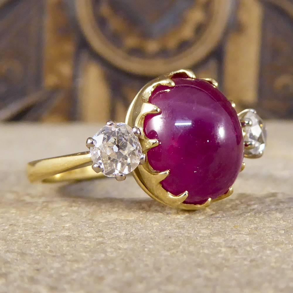 This ring holds antique stones although has been crafted in 2017 in London England in 18ct Yellow Gold, as shown in the very clear hallmarks. Featuring a large 6.79ct Cabochon Ruby in the centre of this three stone, with two Diamonds weighing 0.32ct