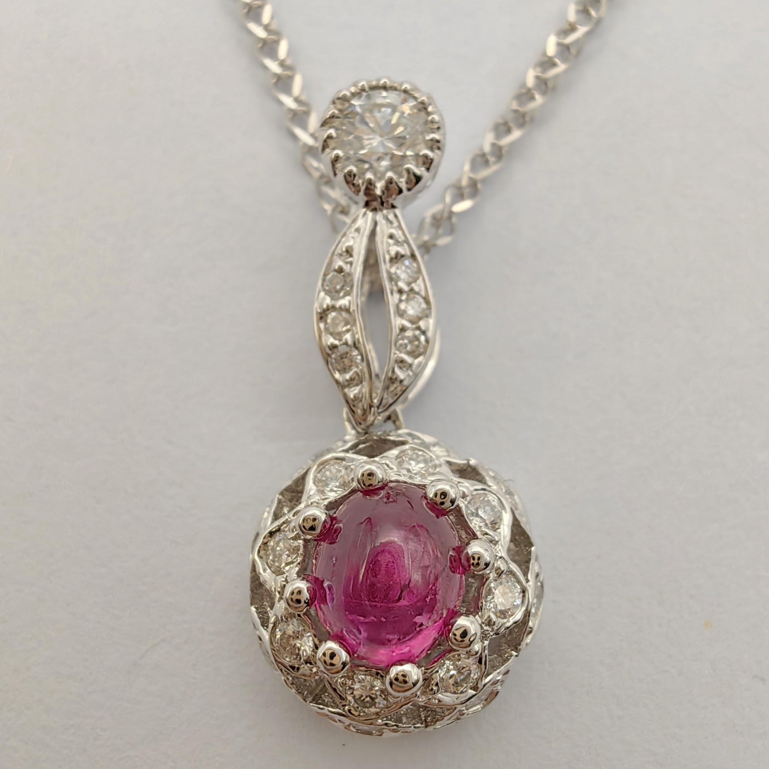 Introducing our exquisite Cabochon Ruby & Diamond Double Halo Necklace Pendant in 18K White Gold – a mesmerizing blend of vintage charm and contemporary elegance.

At the heart of this pendant lies a magnificent cabochon ruby, weighing 0.78 carats.