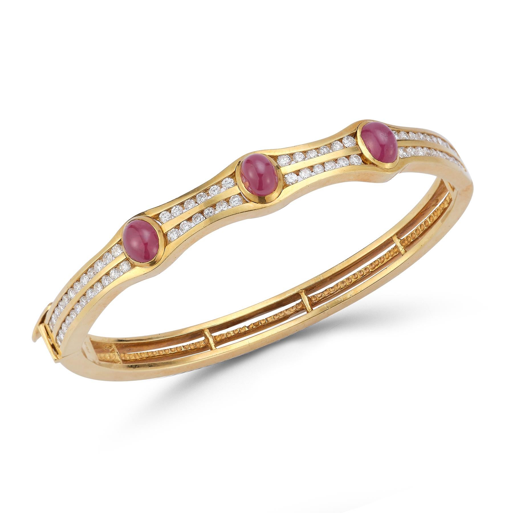 Cabochon Ruby & Diamond Gold Bangle 

3 cabochon rubies weight approximately 4.21 cts with 2 rows of round cut diamonds approximately 1.53 cts set in 18k yellow gold.

Measurements: 2.75