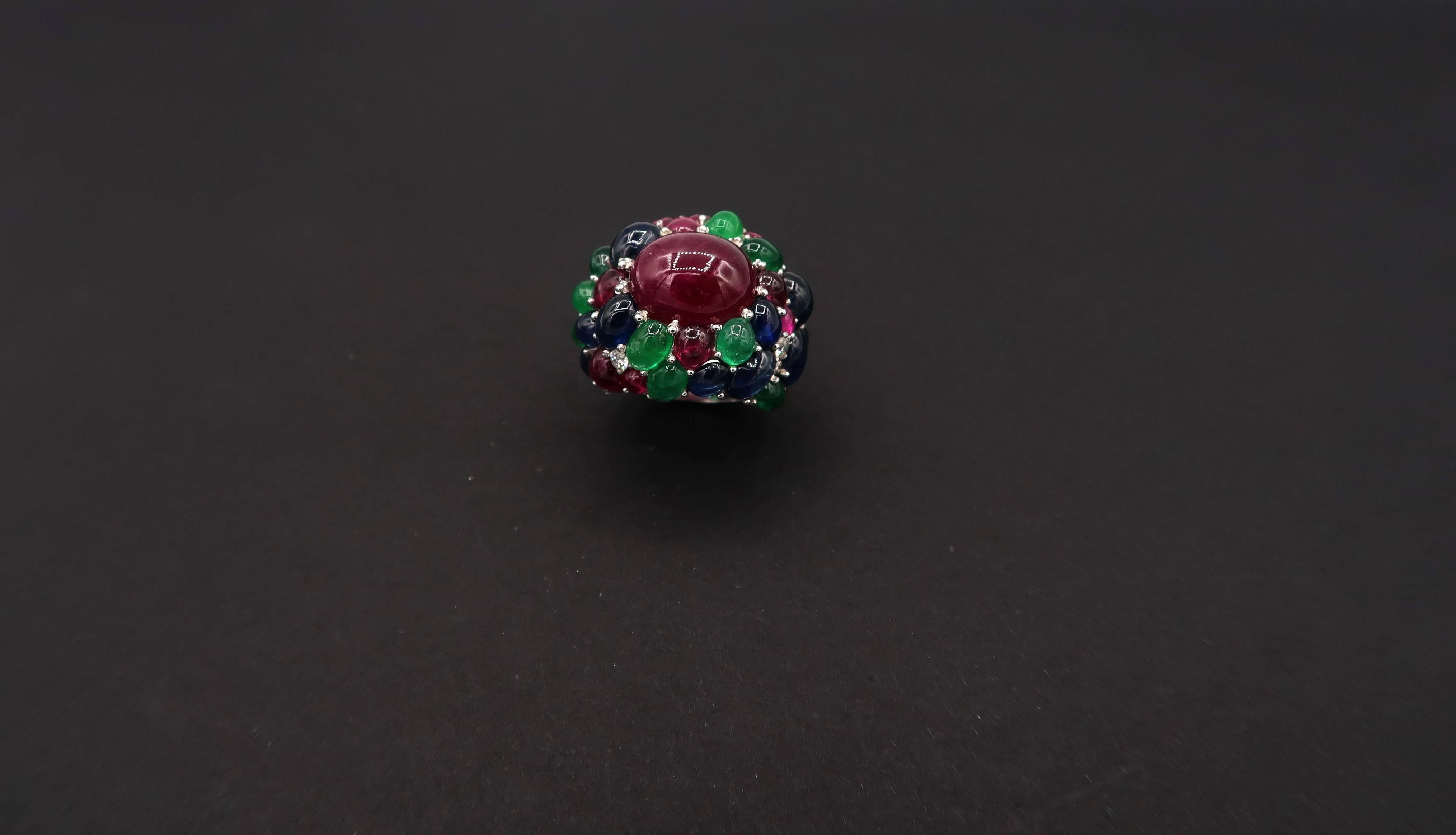 Cabochon Ruby Ring in 18K White Gold Setting Embellished with Cabochon Emerald, Cabochon Rubies, Cabochon Sapphire and Diamonds

We offer a one-time complimentary resizing service for this ring. Should you wish to have the ring resized, please