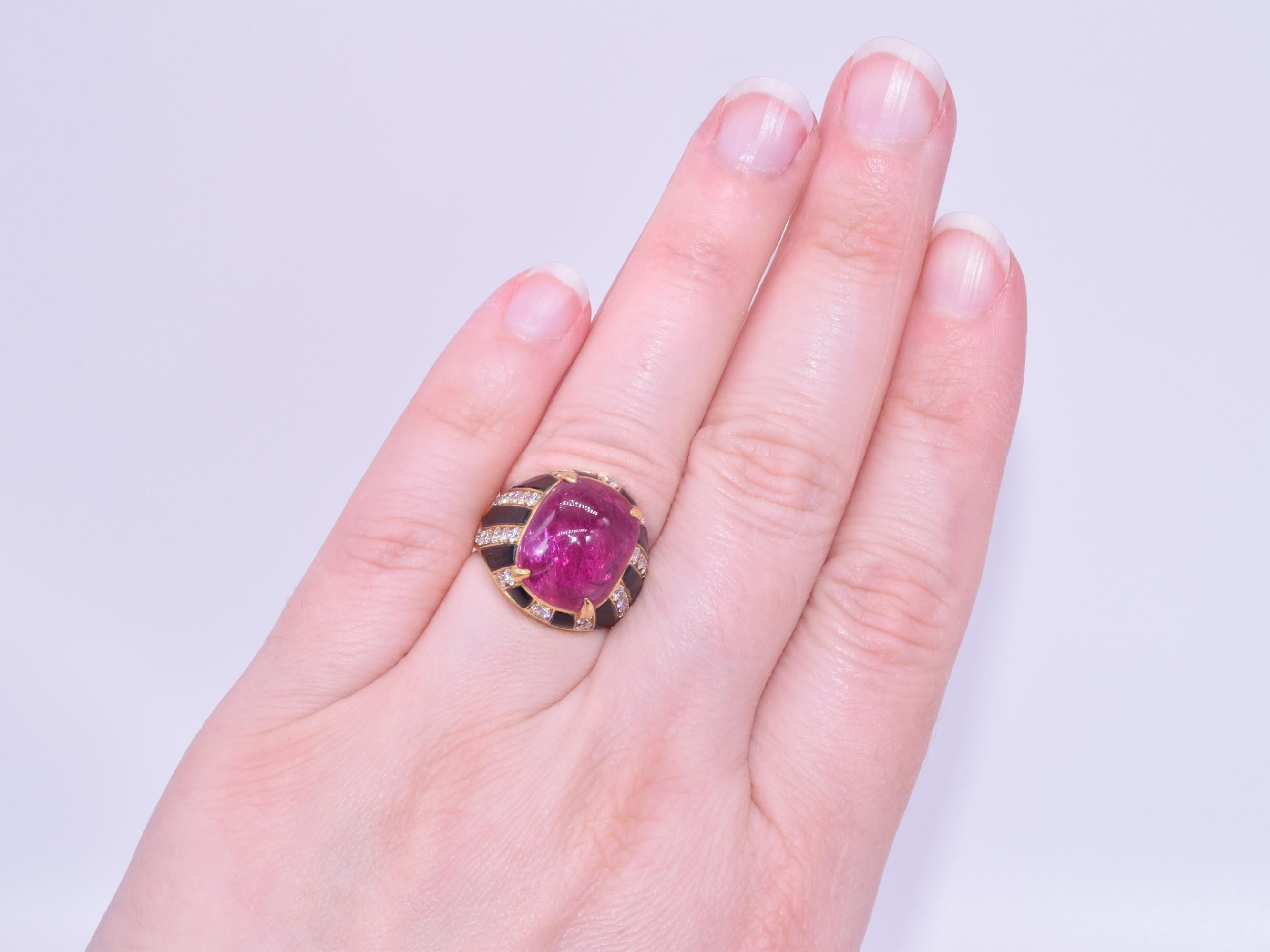 This cabochon ruby, onyx and diamond cocktail ring was designed by Bulgari.  A cushion shaped cabochon ruby weighing approximately 8.66cts, with gemological report from Gubelin stating there are no indications of heat treatment, is set within an