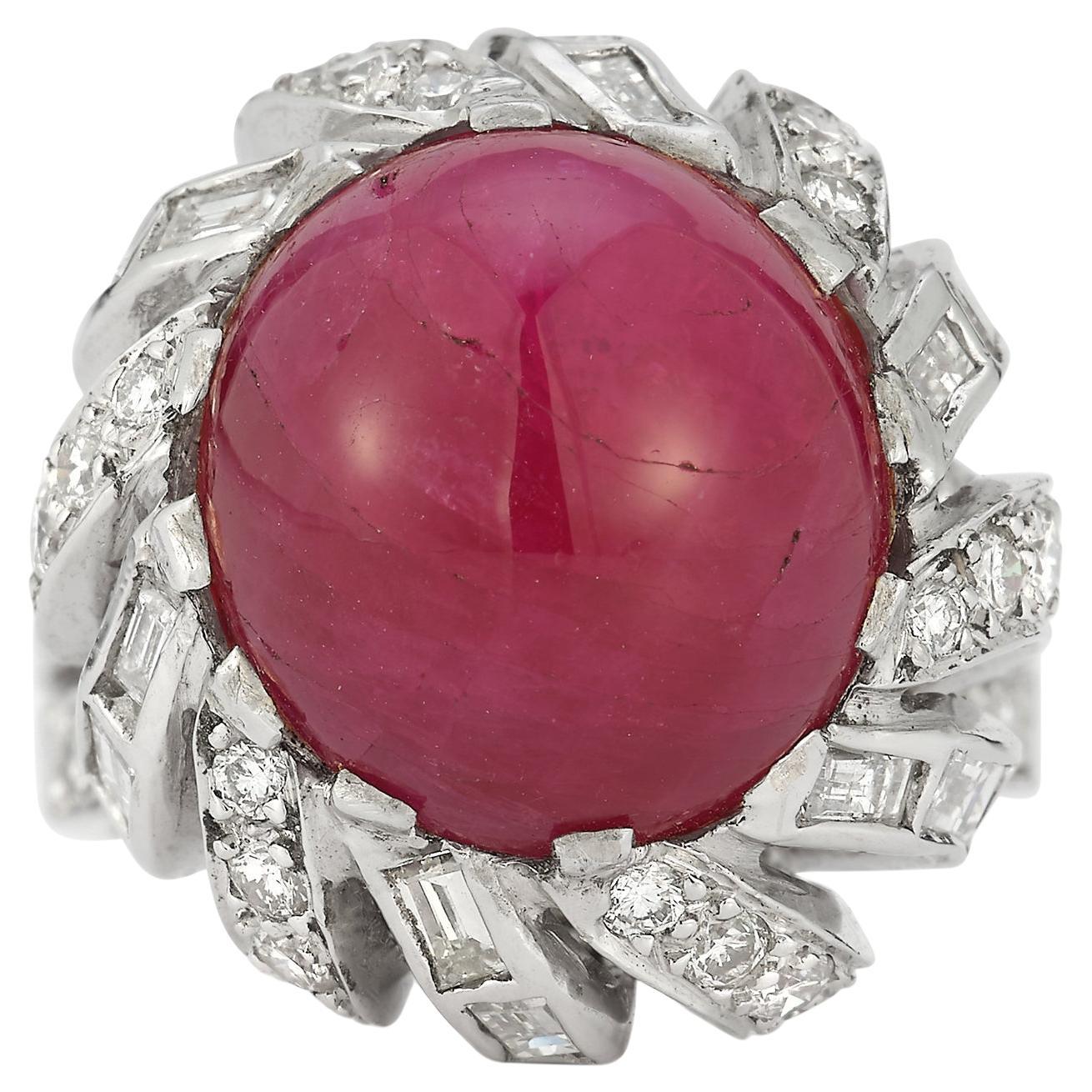 Cabochon Ruby Ring 

1 cabochon center ruby surrounded by round & baguette cut diamonds set in 14k white gold.

Ruby Weight: 15.19 cts 

Diamond Weight: 5.26 cts 

Ring Size: 5.75

Resizable free of charge 

