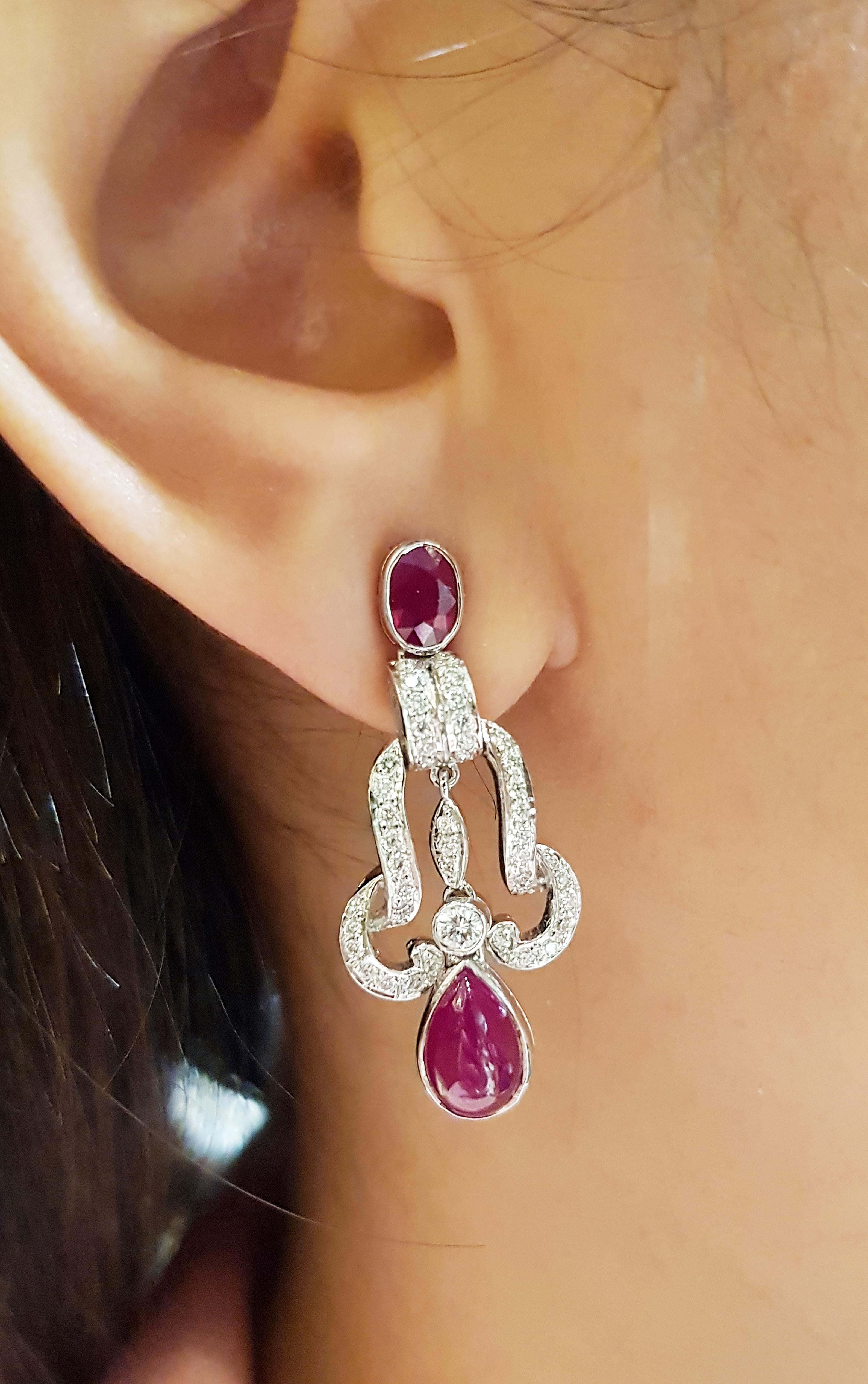 Cabochon Ruby 4.84 carats, Ruby 1.10 carats with Diamond 0.75 carat Earrings set in 18 Karat White Gold Settings

Width:  1.5 cm 
Length: 3.5 cm
Total Weight: 11.87 grams

