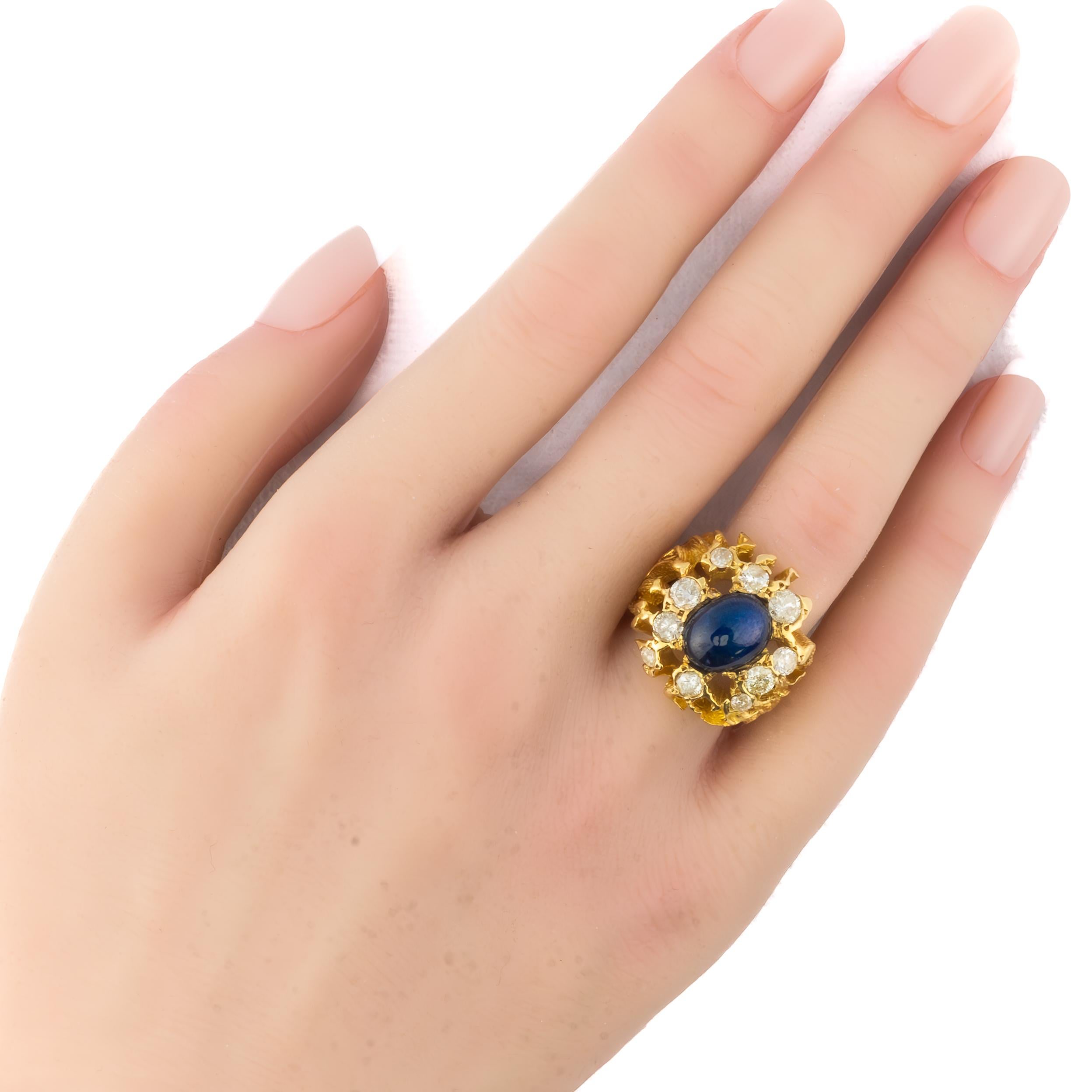 Cabochon Sapphire and Diamond Cocktail Ring

A bold and sculptural creation from the Retro era, this captivating ring showcases a mesmerizing oval cabochon sapphire, exhibiting a luminous asterism that dances across its deep celestial blue surface.