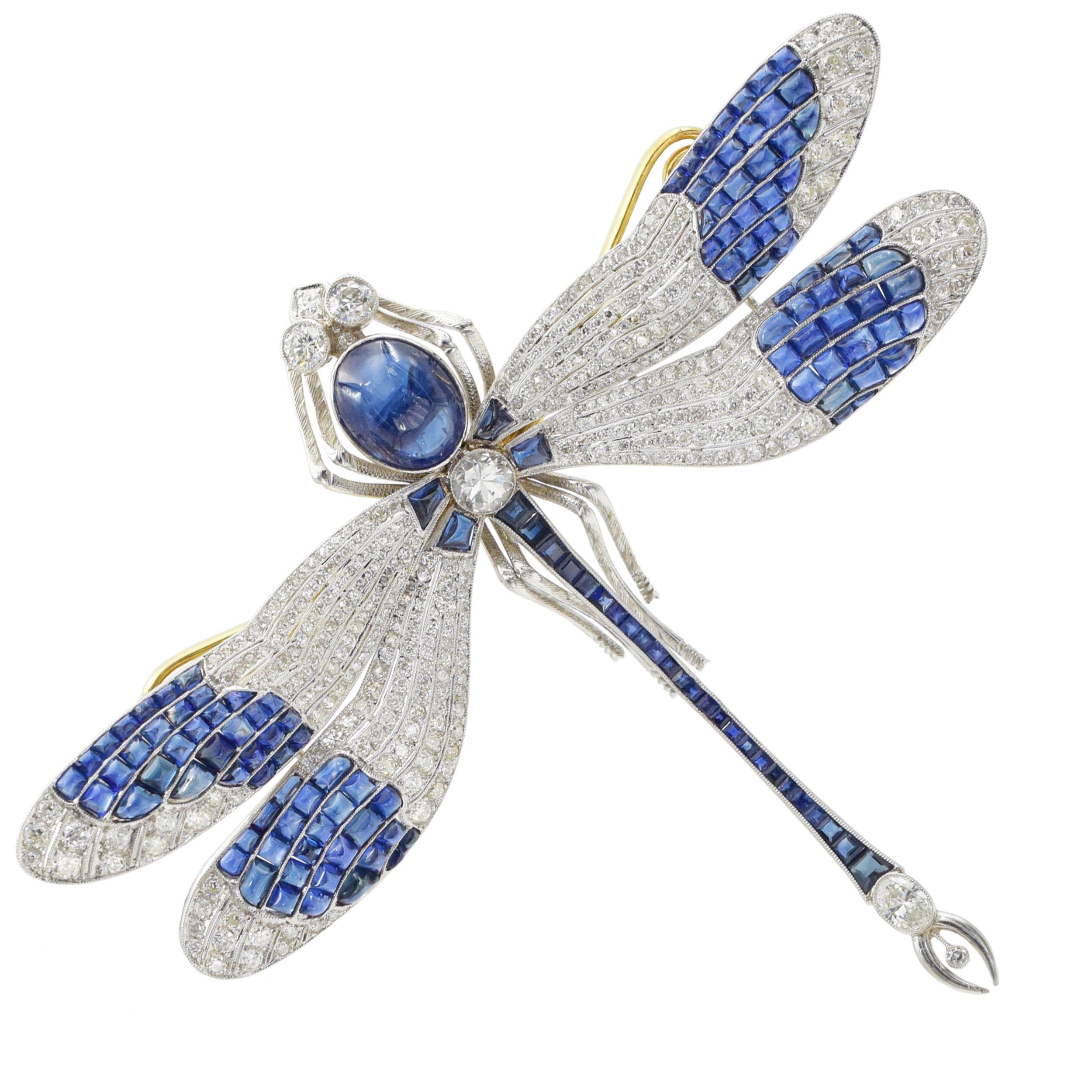 Platinum, Gold, Cabochon Sapphire and Diamond
Dragonfly Brooch This brooch has a center oval cabochon sapphire approx. 9.80 carats., one oval, 3 round and transitonal -cut diamonds ap. 1.60 carats, old-mine and
single-cut diamonds ap. 4.50 carats.,
