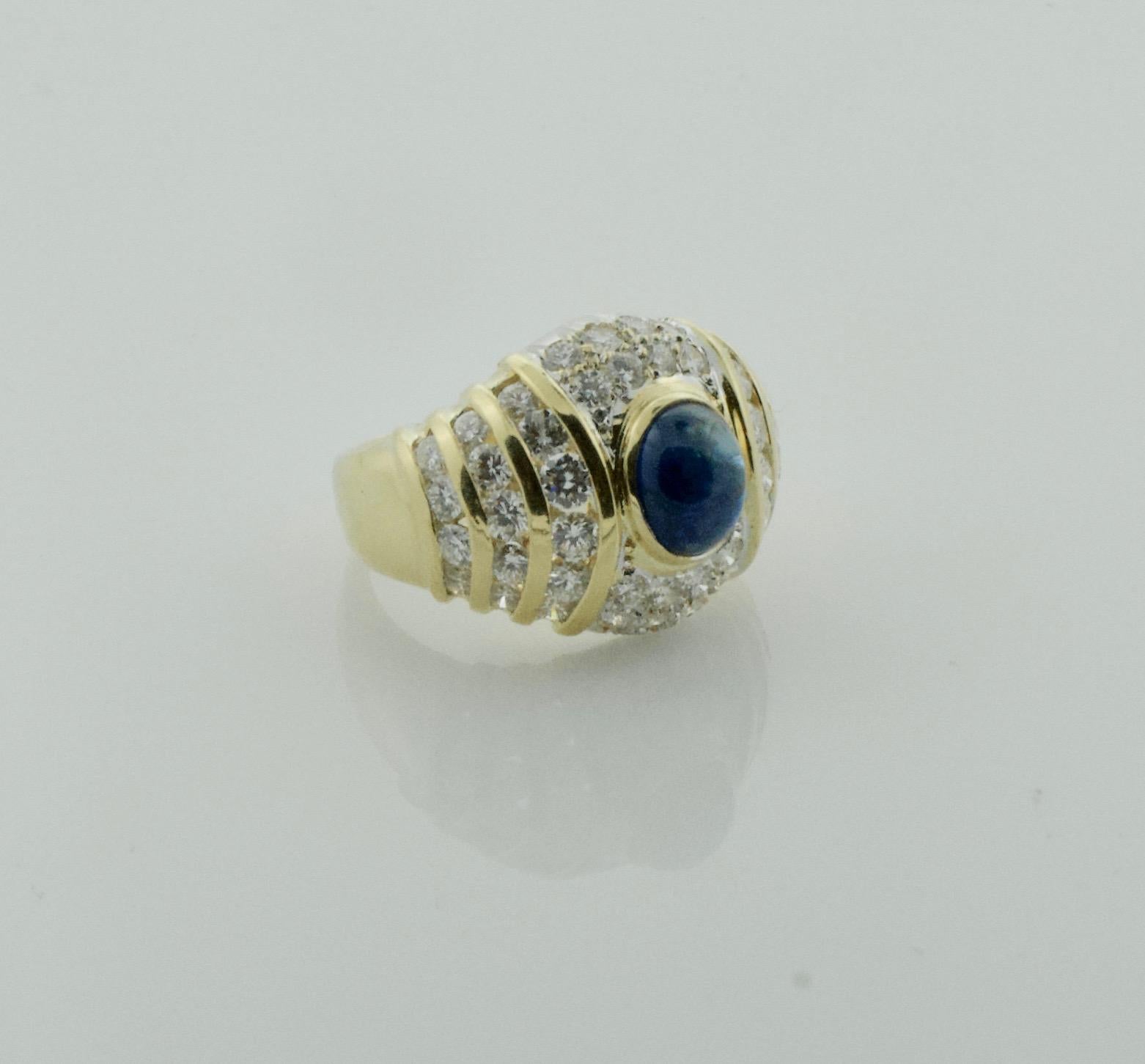 Sapphire and Diamond Fashion Ring in 18k Yellow Gold Circa 1970's
One Oval Cabochon  Sapphire Weighing 1.75 Carats Approximately [bright with no imperfections visible to the naked eye]
Forty Six Round Brilliant Cut Diamonds Weighing 1.70 Carats