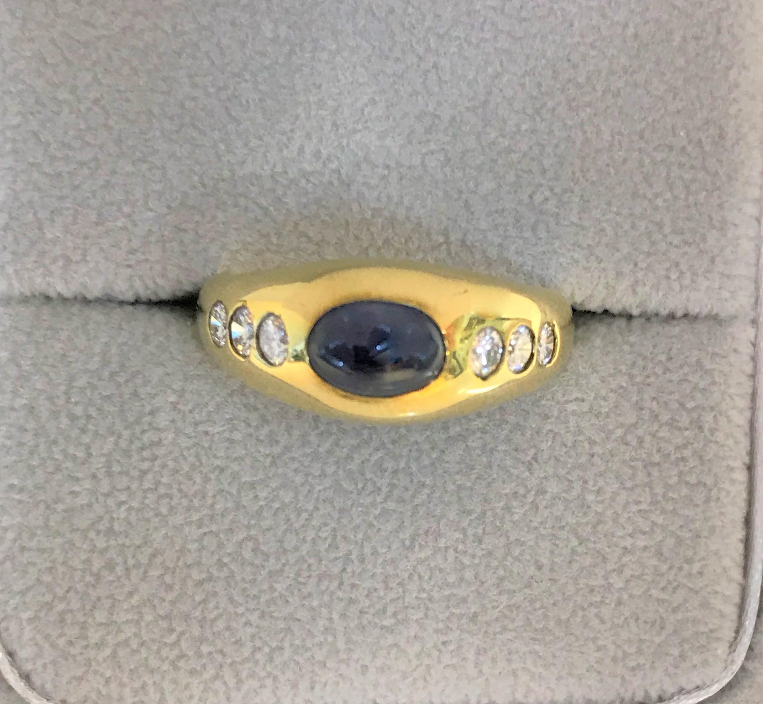 14 karat yellow gypsy style ring
Oval cabochon blue sapphire approximately 6mm x 4.5mm x 3.5mm, approximately 1.40 carat, set horizontally
6 round diamonds approximately .36 total diamond weight
Stamped 