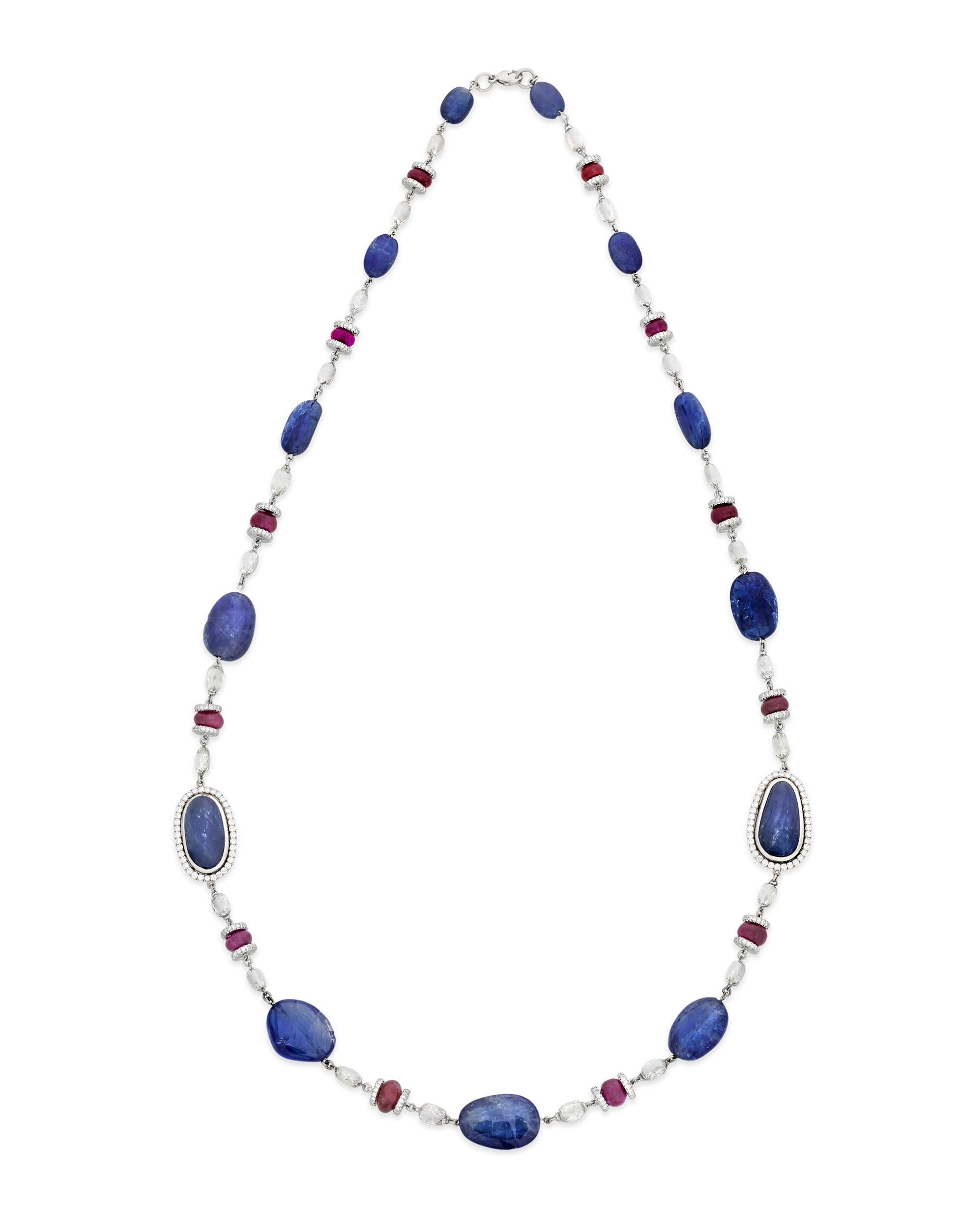 This highly unique, one-of-a-kind necklace is set with an array of cabochon sapphires and rubies. Beautifully polished with smooth surfaces and organic shapes, these gems display the best natural attributes of their gem type. The stones, which total