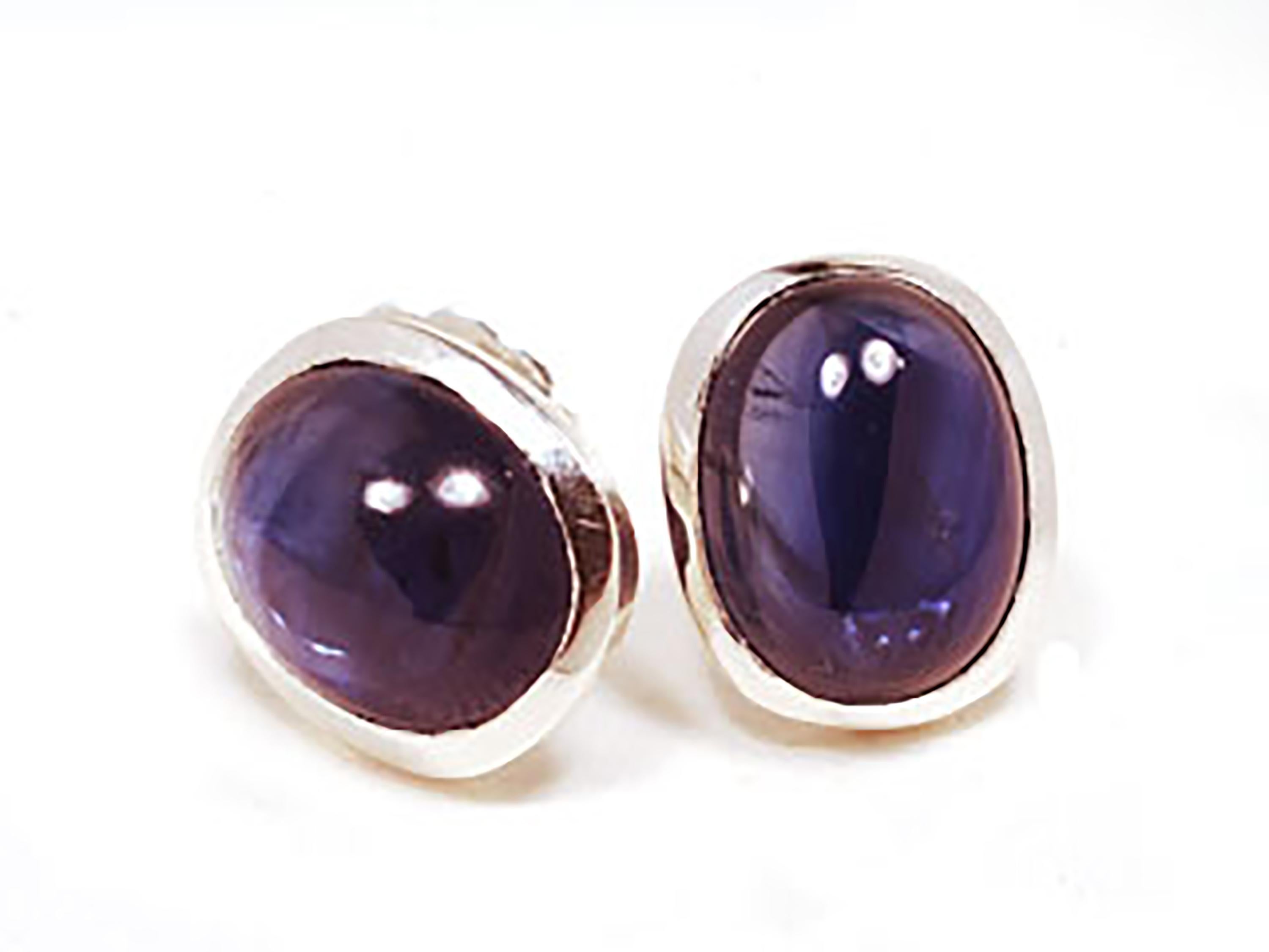 Sterling silver stud earrings
Two perfectly matched genuine oval cabochon sapphires weighing  8.00 carats
Earrings measuring  12x10 millimeter
Cabochon sapphires measuring 10x8 millimeter
New earrings
Handmade in the USA
White gold plated
