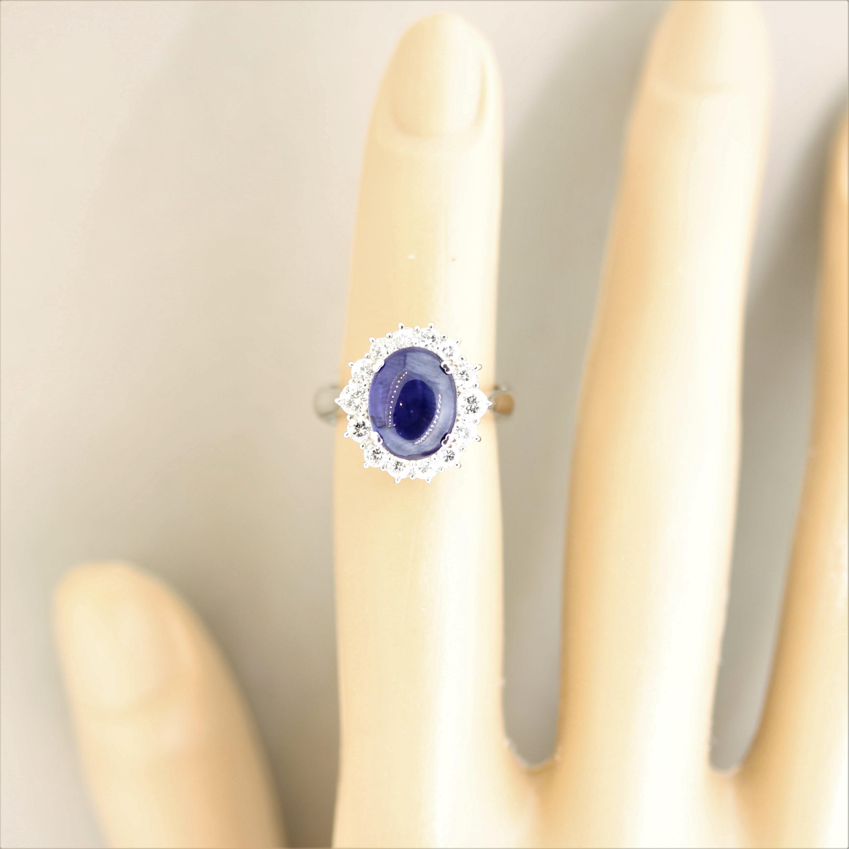 A luscious vivid blue sapphire takes center stage! It weighs 4.58 carats and has a rich evenly blue color that pleases the viewer. It is accented by 0.73 carats of fine round brilliant-cut diamonds that halo the sapphire and add brilliance and