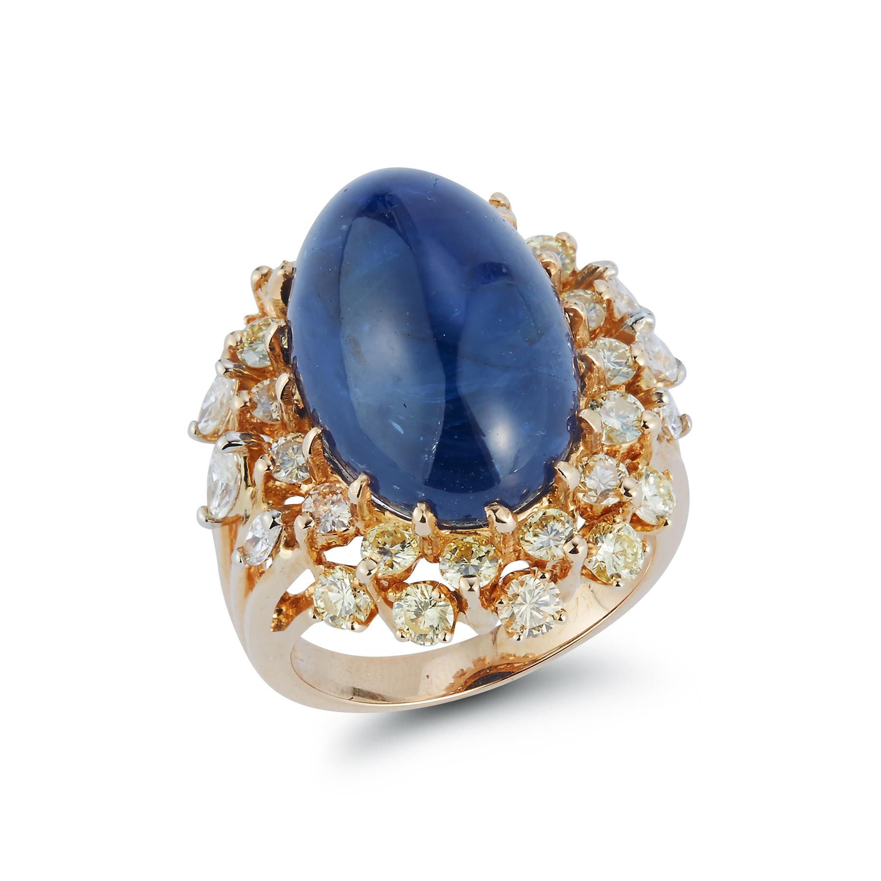  Cabochon Sapphire & Diamond Ring

 AGL certified Cabochon Sapphire  25.59 cts surrounded by a stunning array of Diamonds including 6 Marquise Diamonds & Round Cut Diamonds

Ring Size: 5.75

Resizable Free of Charge