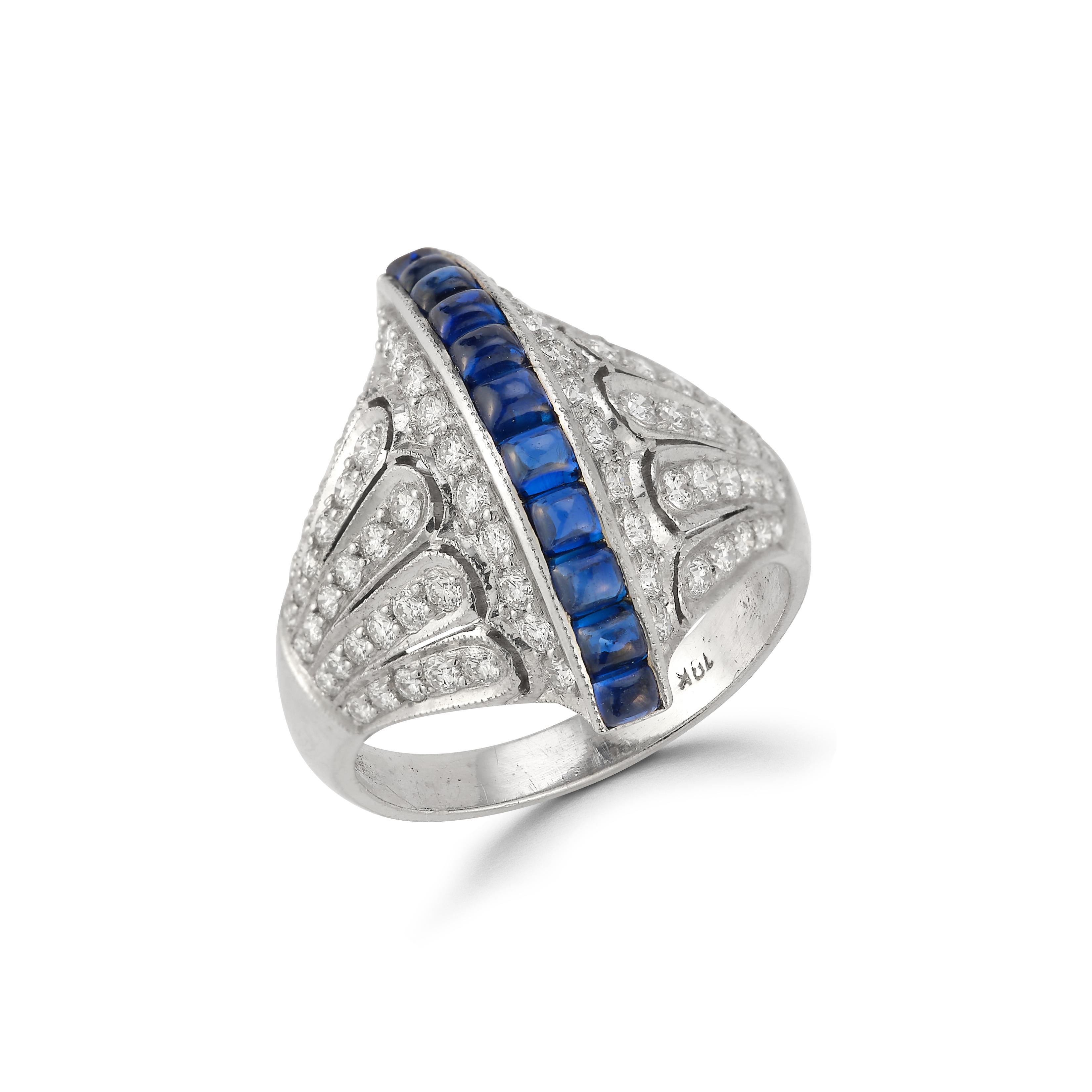 Sapphire Row & Diamond Ring 

18k white gold ring set with a center row of 11 buff cut cabochon sapphires surrounded by 78 round diamonds

Approximate Diamond total weight: 1 carat
Approximate Sapphire total weight: 1.75 carats 

Ring Size: