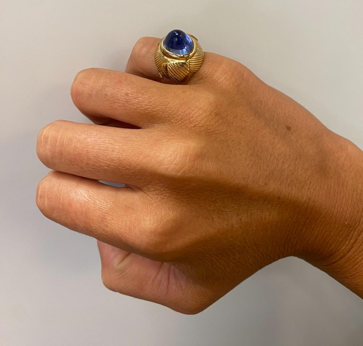 Cabochon Sapphire Ring 

A unusually tall pyramidical cabochon sapphire ring set in a engraved gold dome band.

Accompanied by AGL laboratory certificate stating the sapphire is of Ceylon origin and natural with no treatment

Approximate Sapphire