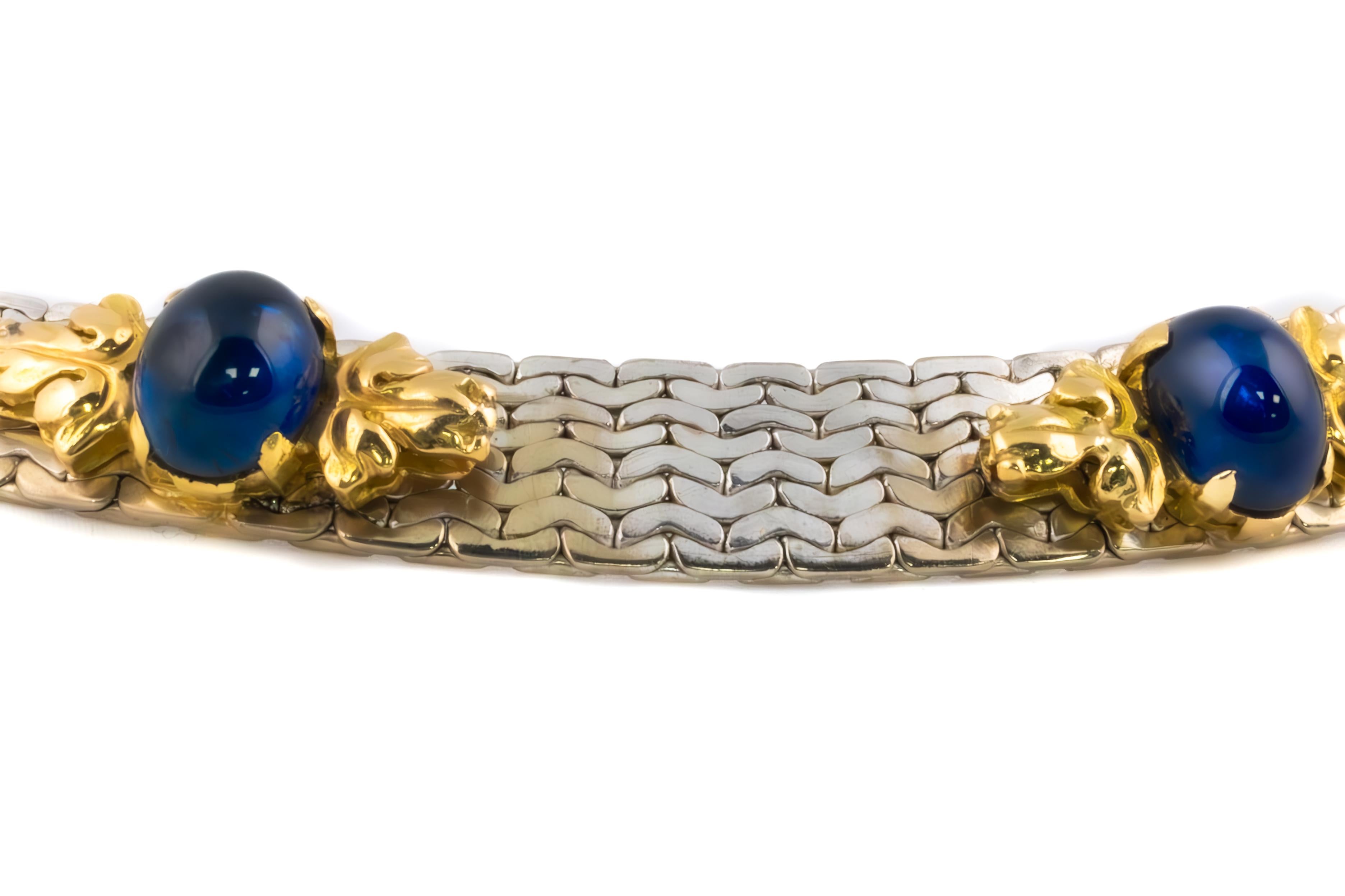 Cabochon Sapphire White and Yellow Gold Necklace

Description:
A strikingly modern yet regal creation, this two-tone gold necklace is crafted in a broad woven design of white gold, adorned with ornate yellow gold accents and set with eight richly