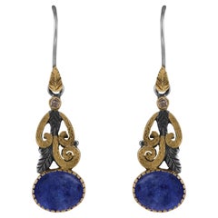 Orecchini a pendente con diamante e tanzanite cabochon in oro 18k e argento