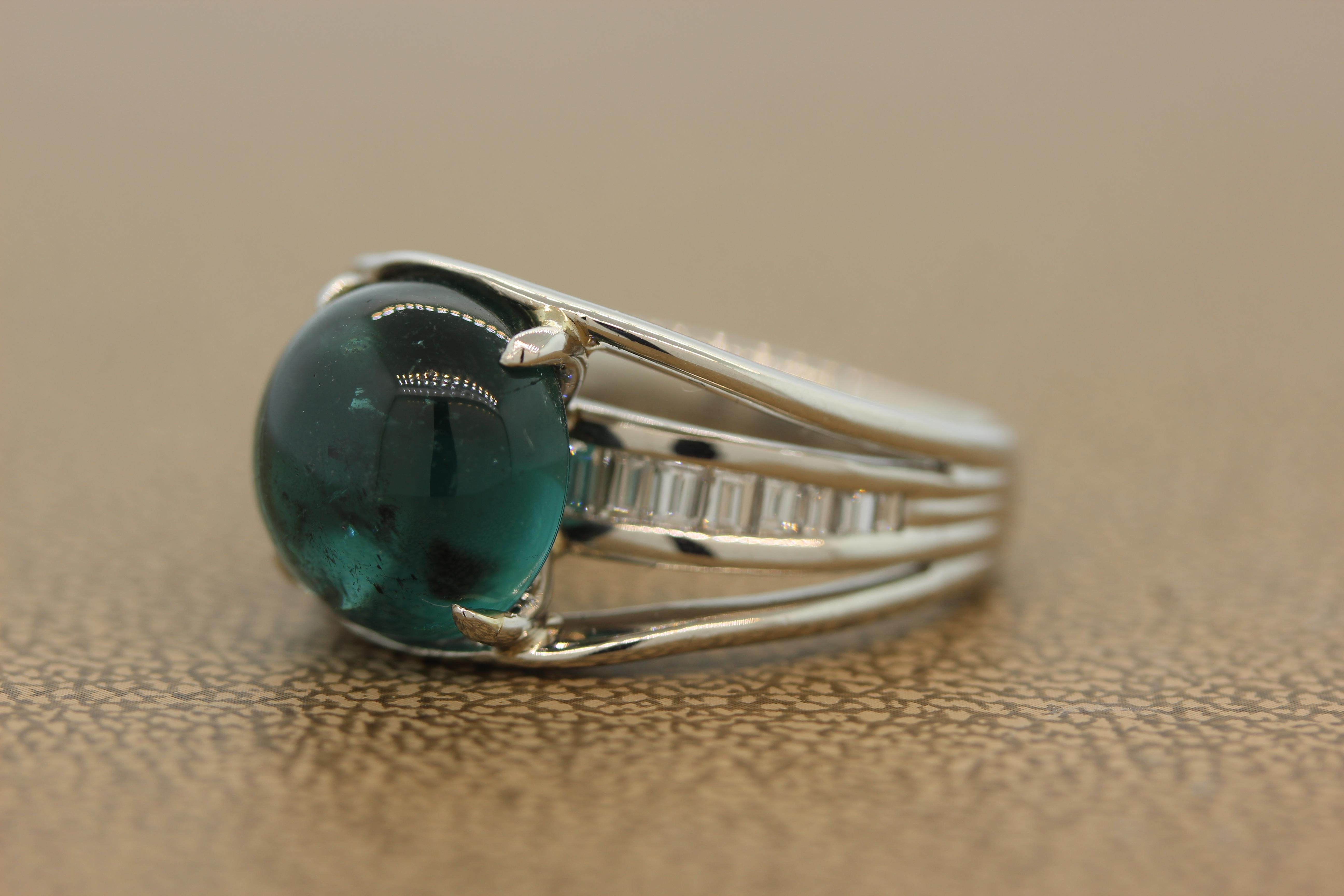 A unique ring featuring a 7.23 carat tourmaline with a luscious and deep blue-green color. The cabochon gem is accented by 0.60 carats of channel set baguette cut diamonds. Its distinctive platinum setting has a split shank making this ring a