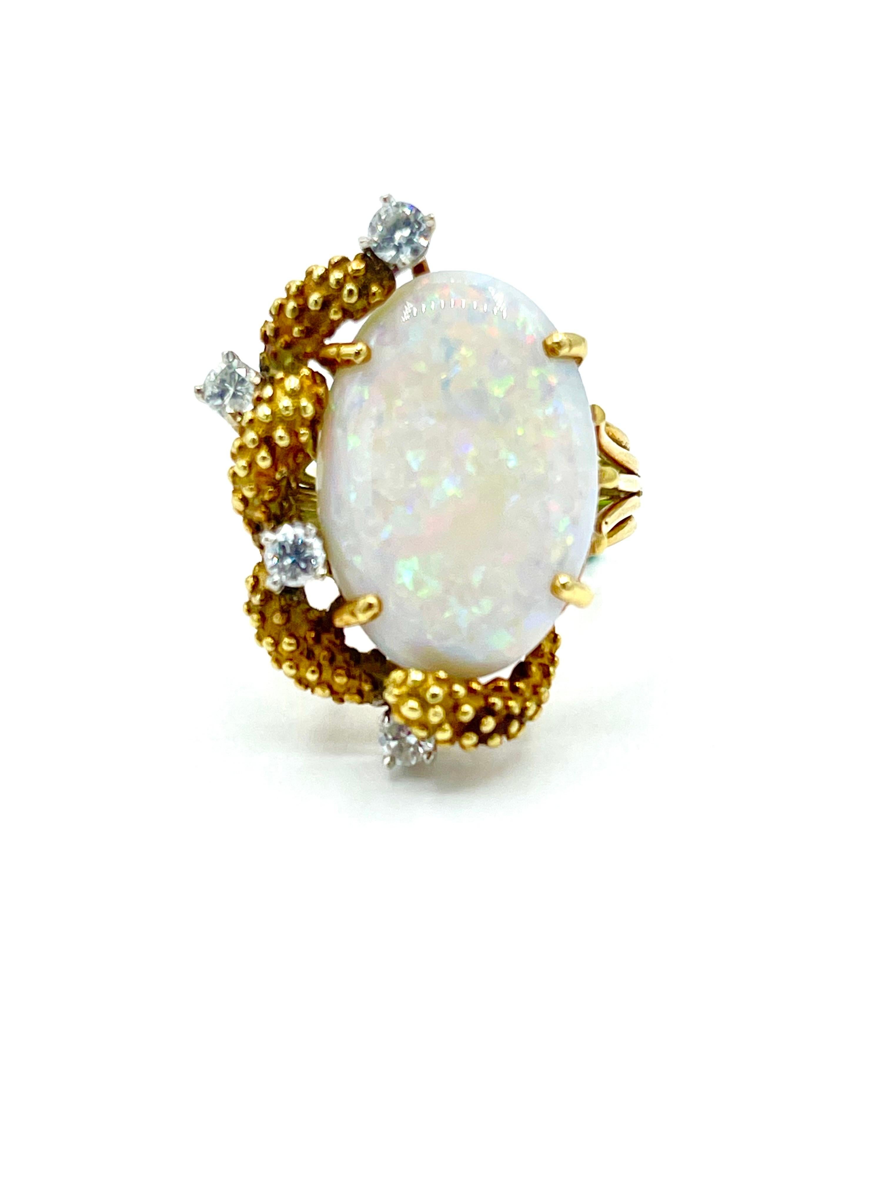 An amazing white Opal cocktail ring!  The Opal is set in four prongs, with four round brilliant Diamonds and textured 18k yellow gold to one side.  The four Diamonds have a total weight of 0.46 carats, and are graded as G-H color, SI clarity.   The