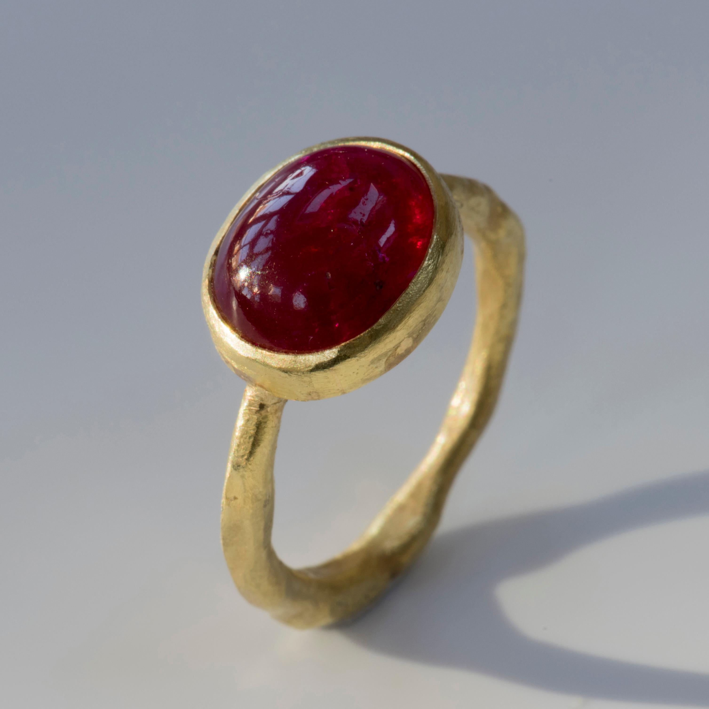 18k yellow gold organic texture ring with oval Cabouchon Ruby, 12x10mm, from Kenya. 
Handmade by Disa Allsopp in her London studio, this ring showcases a stunning example of cabouchon cut ruby, with its warm deep glow.

Disa is known for her