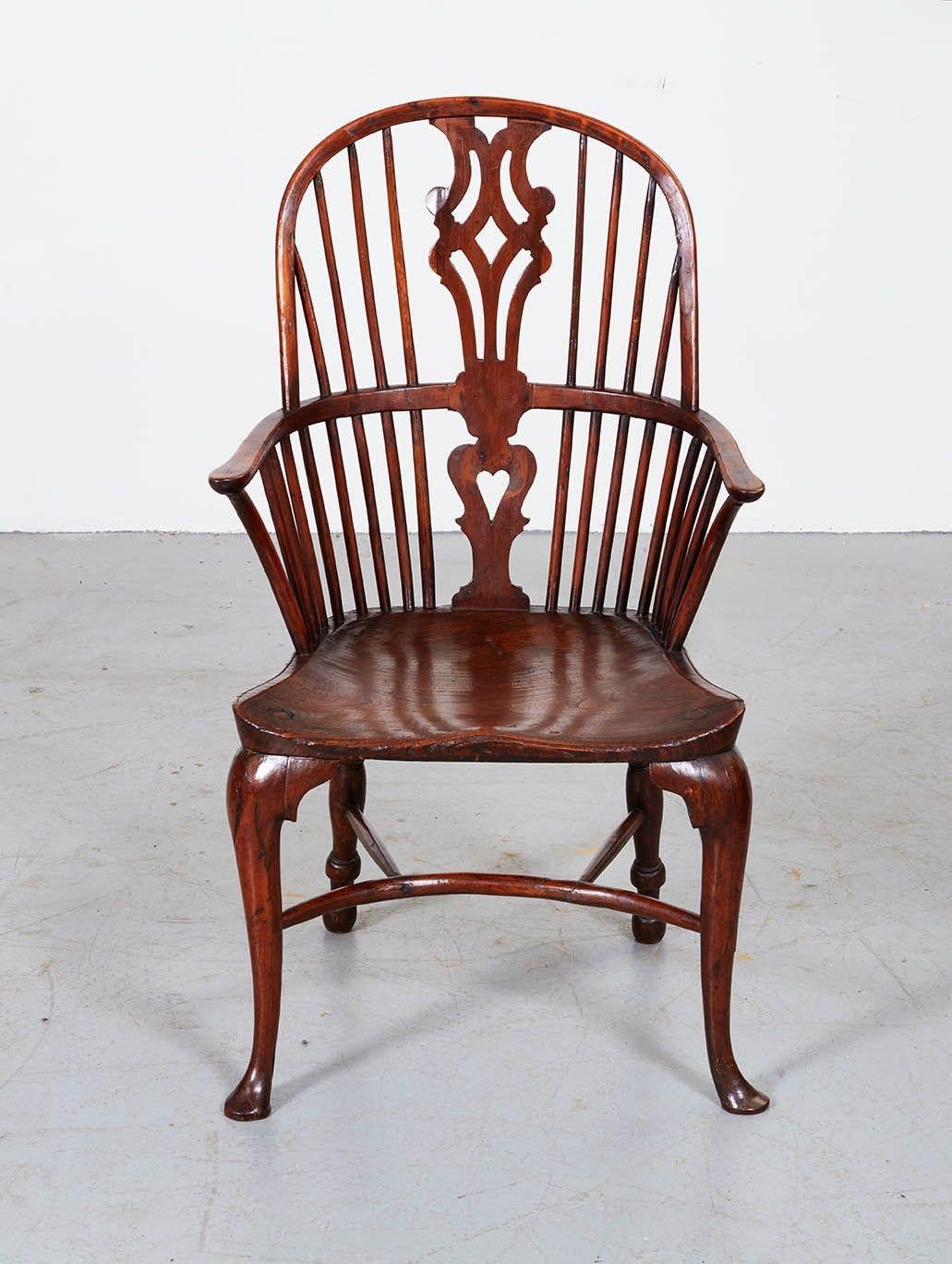 An 18th century yew wood windsor armchair having hooped spindle back with fretted central splat over saddled elm seat standing on front cabriole legs and turned back legs joined by a crinoline curved stretcher. English, George II, circa 1750.
Width: